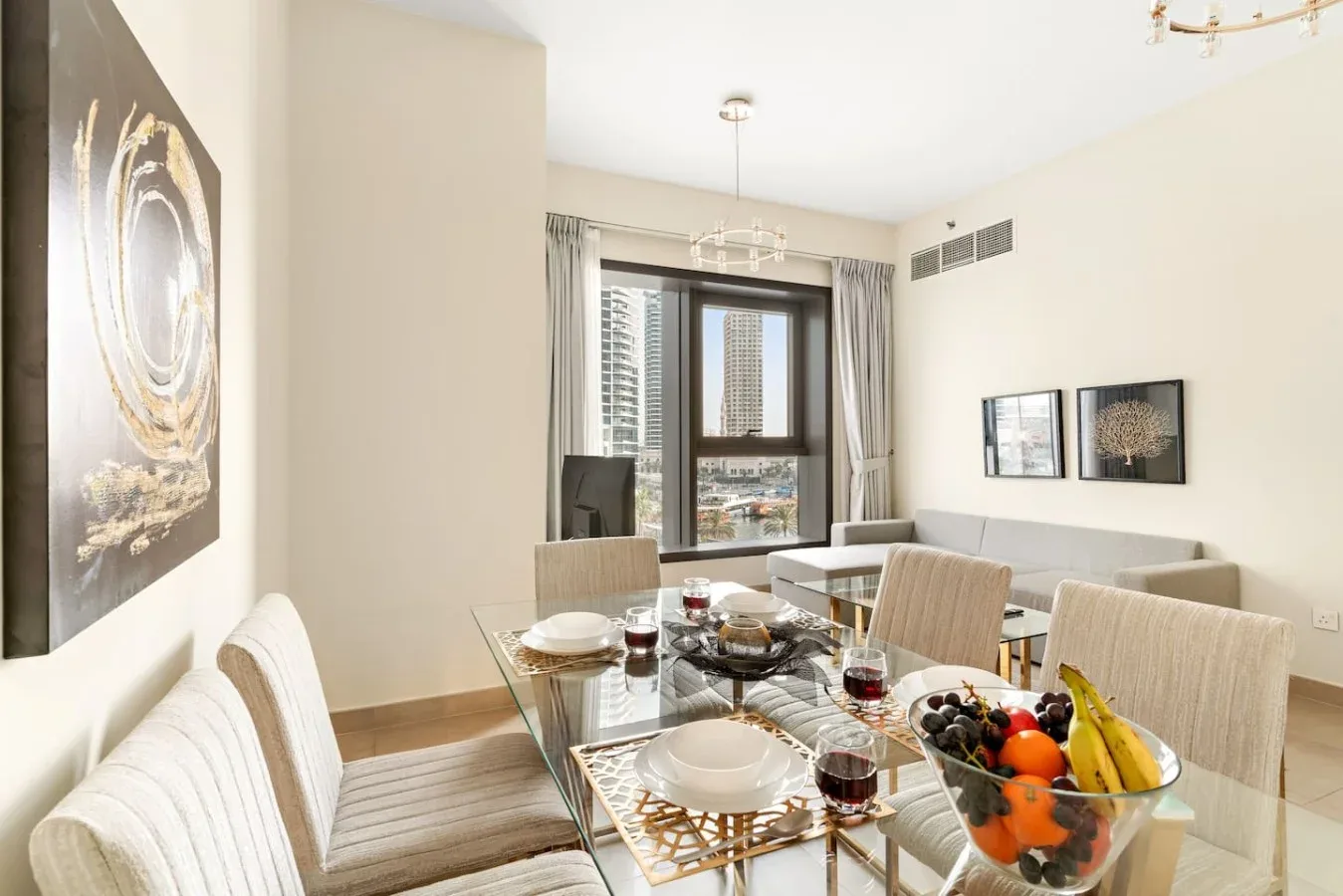 A bright dining area with a glass table and large windows.