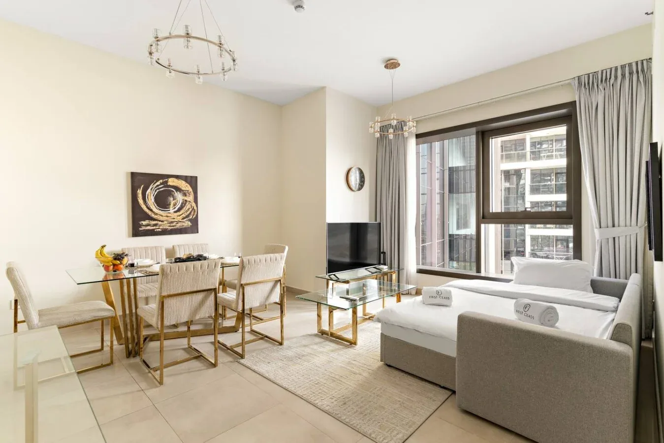 A bright living and dining area with seating beside large windows.