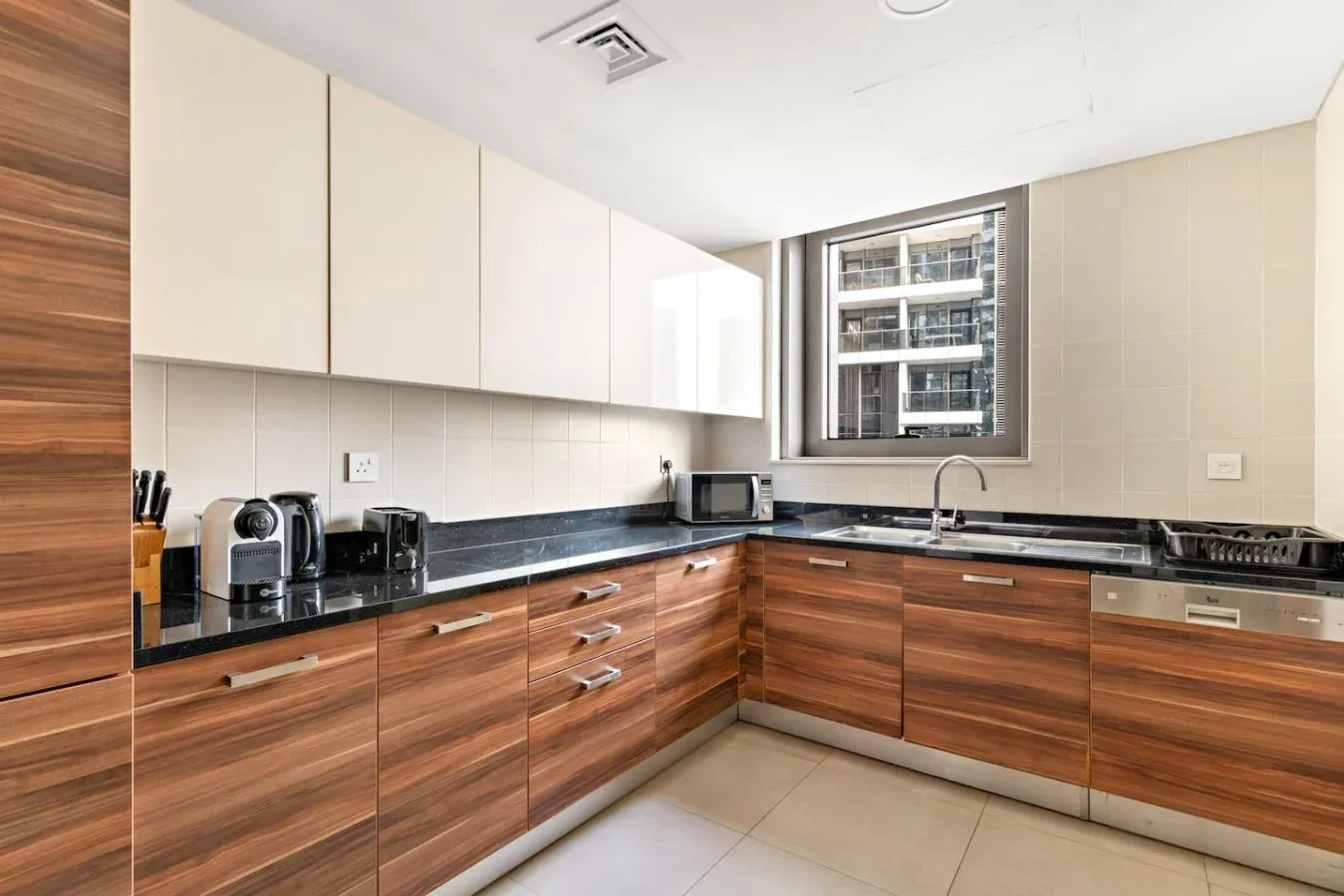 A modern kitchen with wood-toned cabinets and a countertop along two walls.