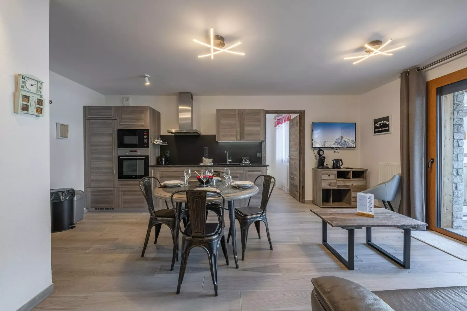 An open-plan kitchen and dining area with a table and seating.