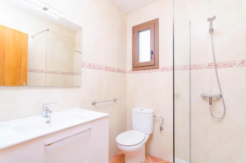 A bathroom with a sink, toilet, and shower.