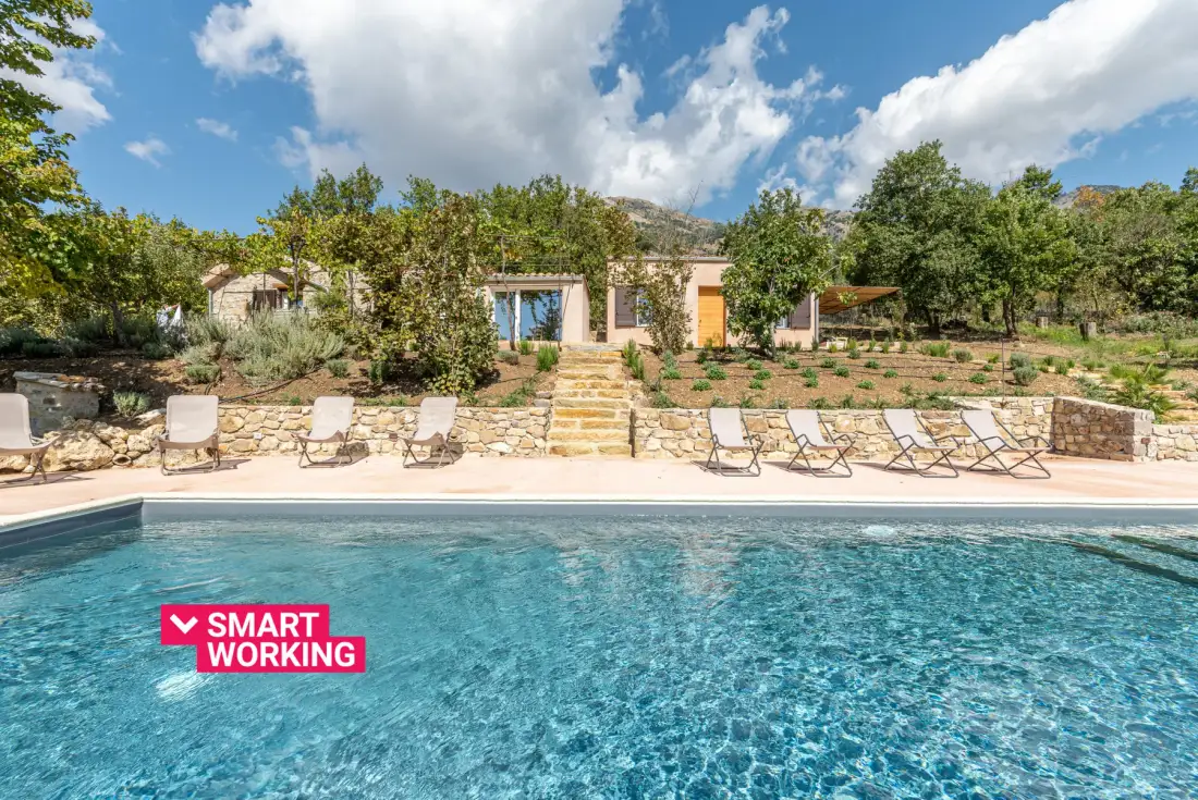 Outdoor swimming pool with lounge seating and a landscaped garden.