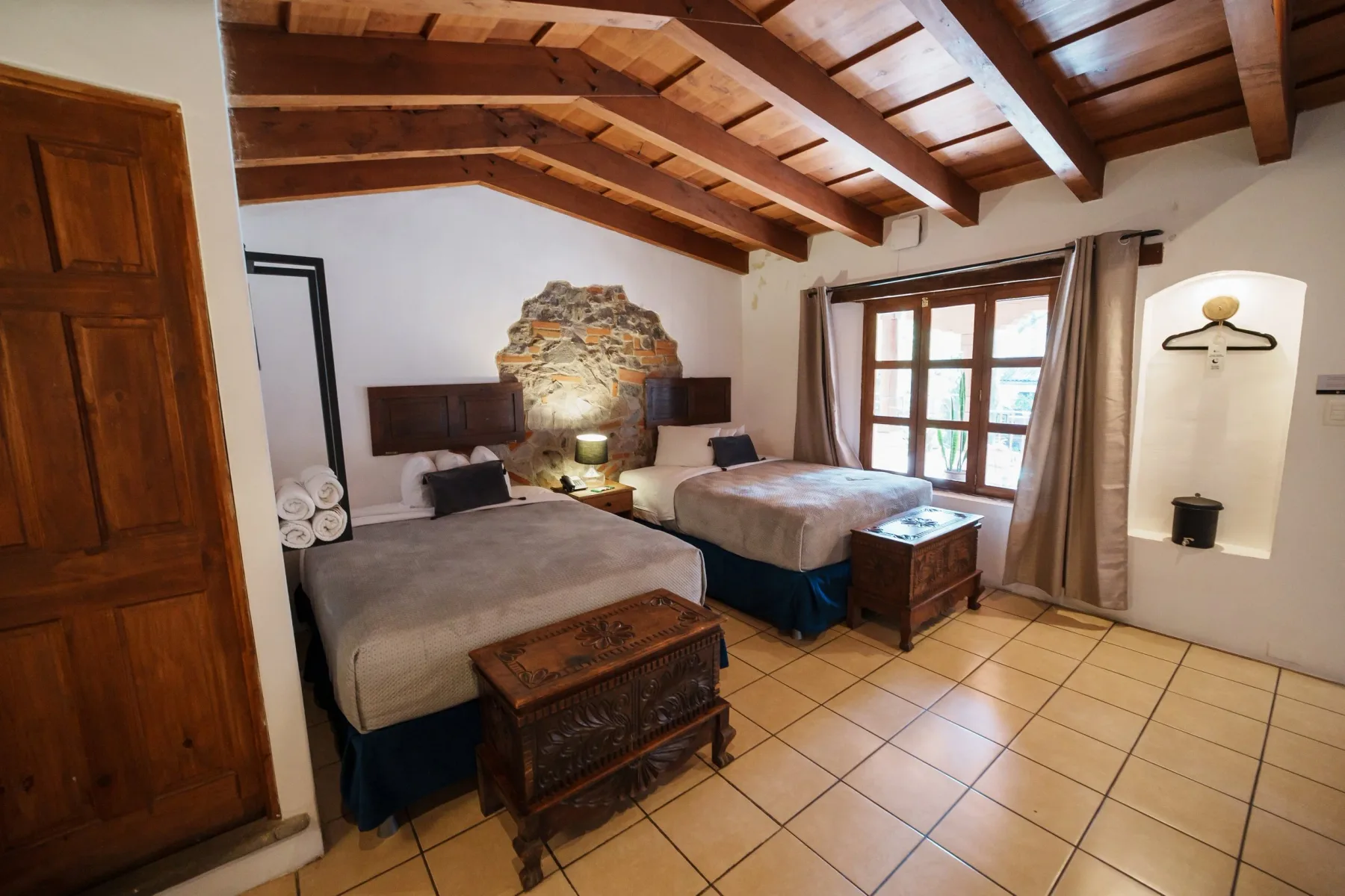 Hotel room with wood and stone details.