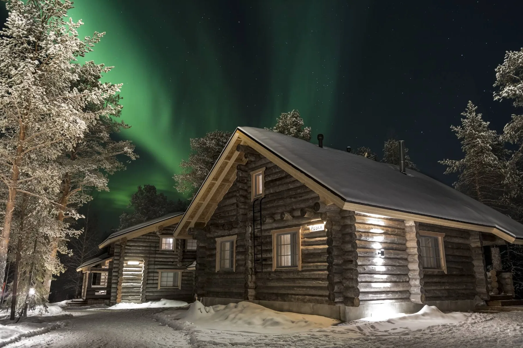 Log cabins beneath the northern lights