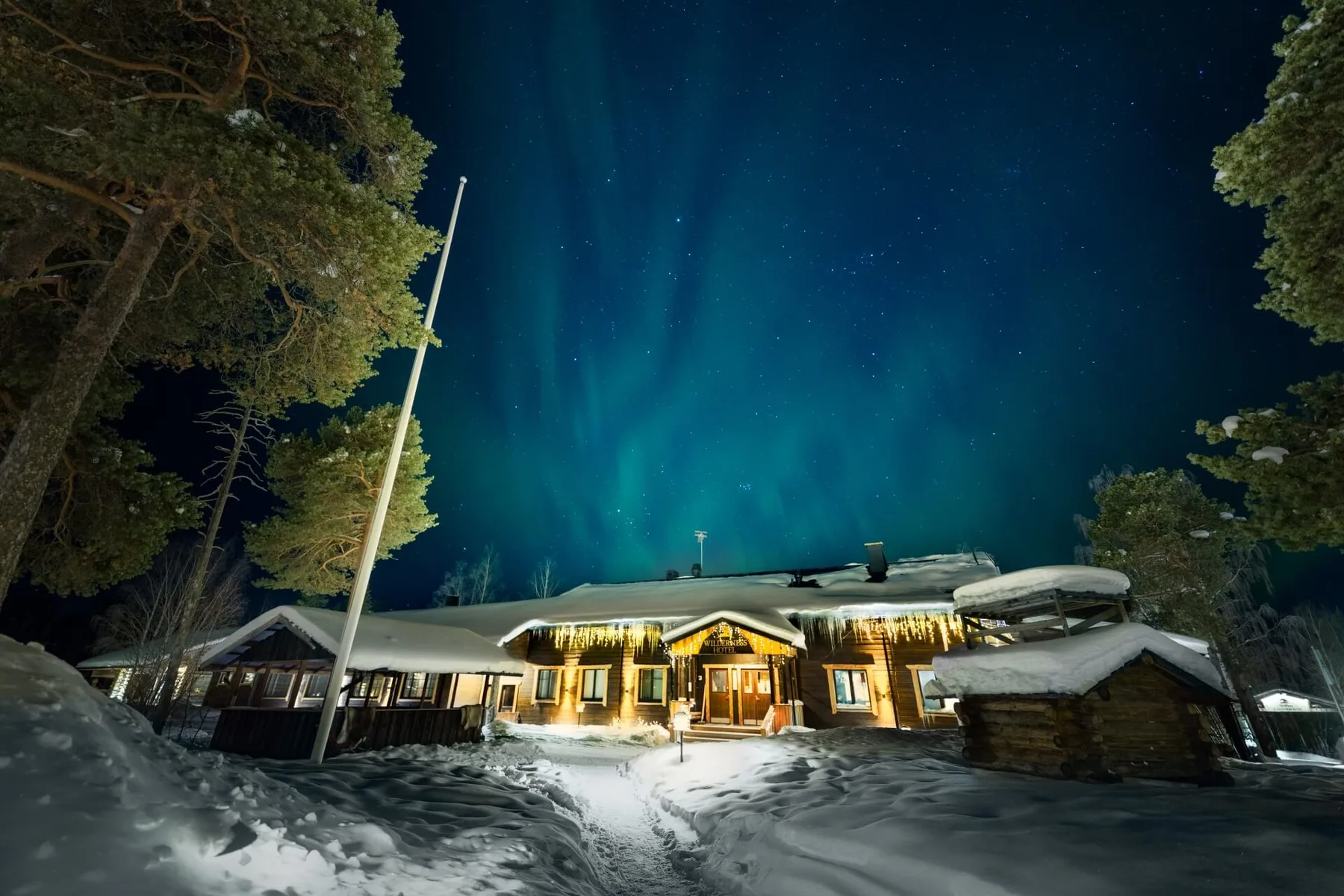 Wooden lodge beneath the northern lights