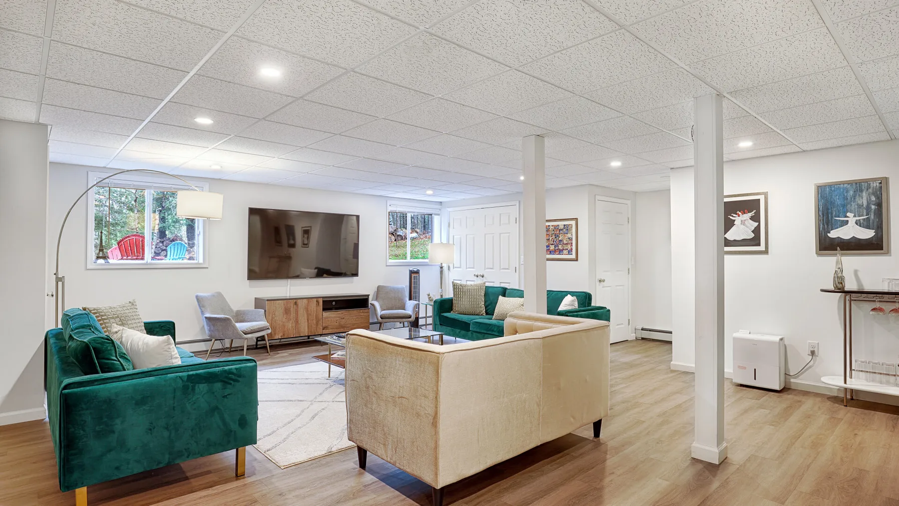 A living room with seating arranged around a coffee table and television.