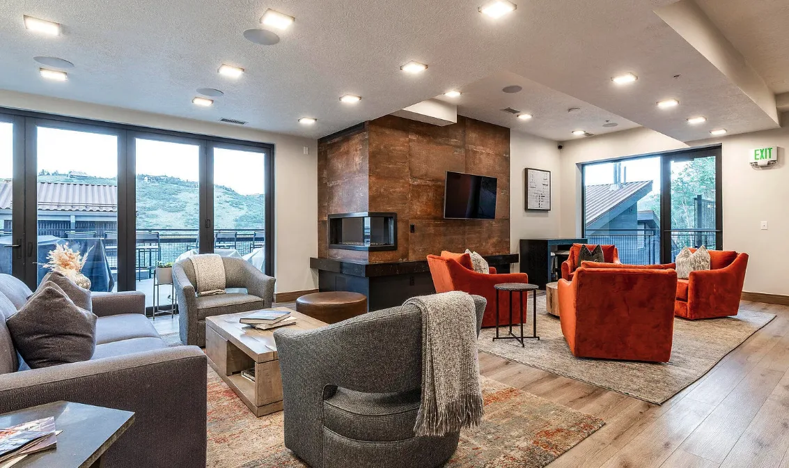 A spacious lounge with several seating areas and large windows overlooking the outdoors.