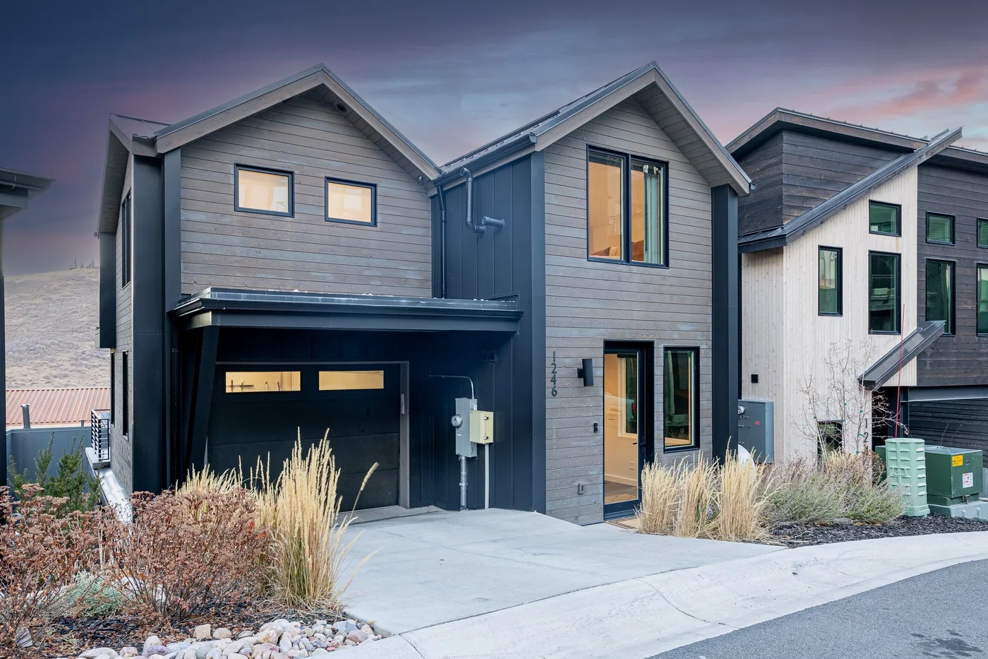 A modern house exterior with a driveway and garage.