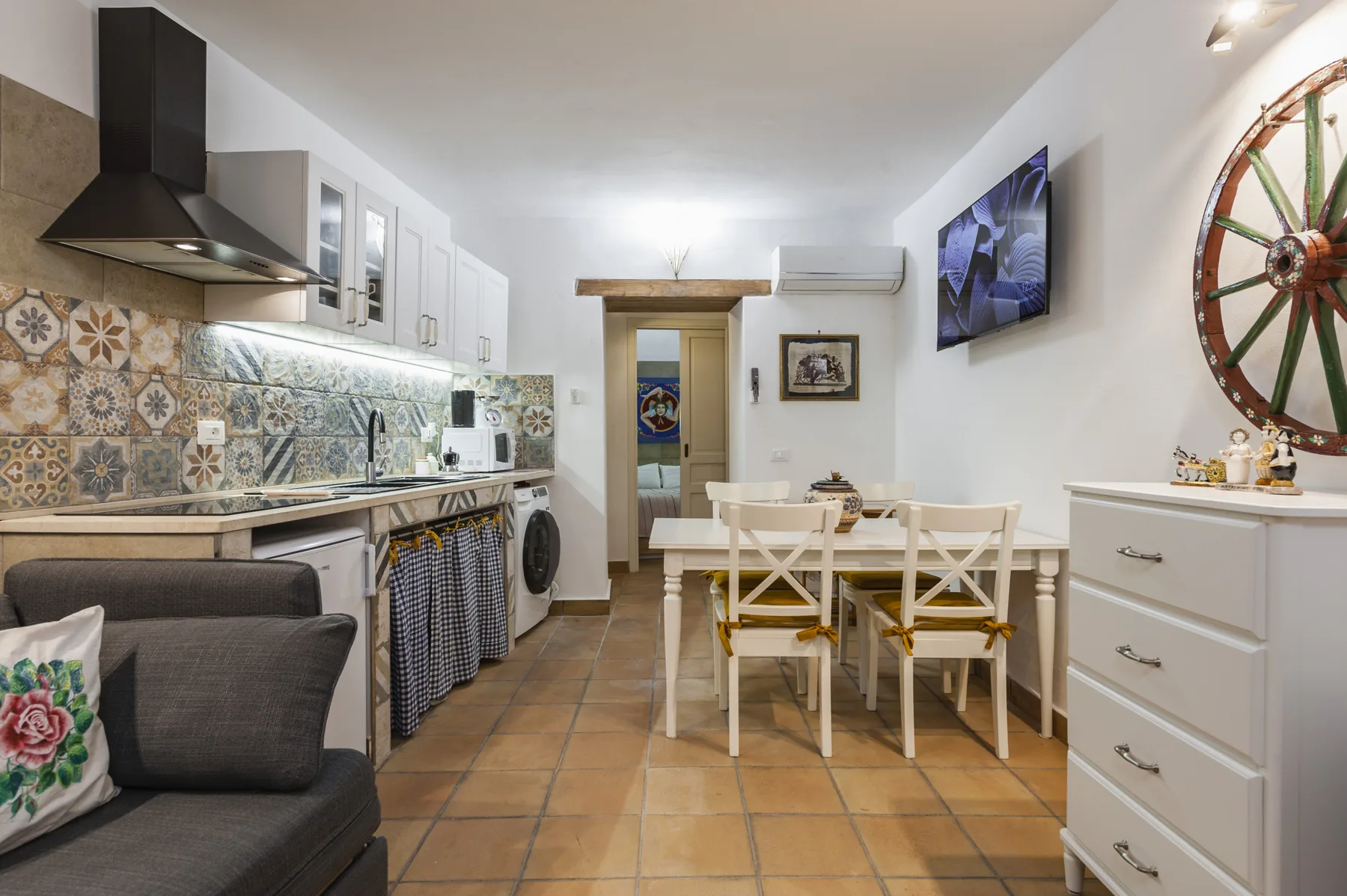 Una cocina y comedor con una mesa y asientos.