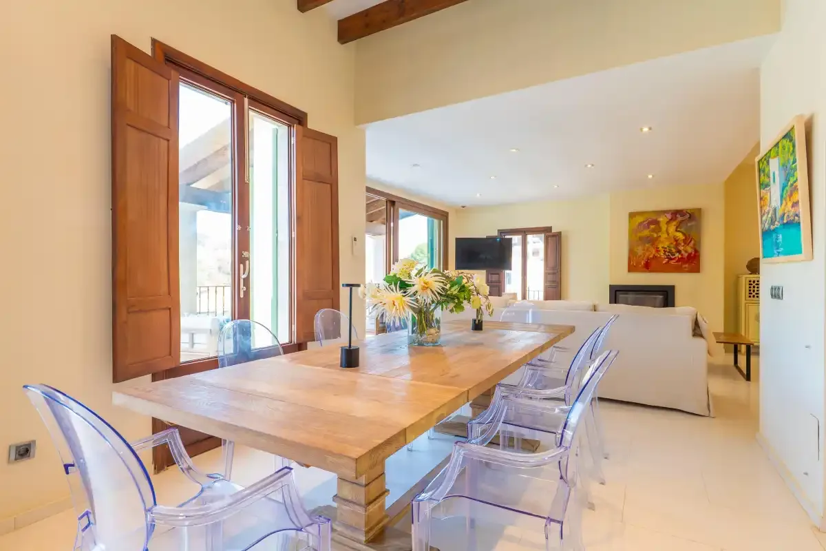 An open-plan living and dining area with a wooden dining table and seating.