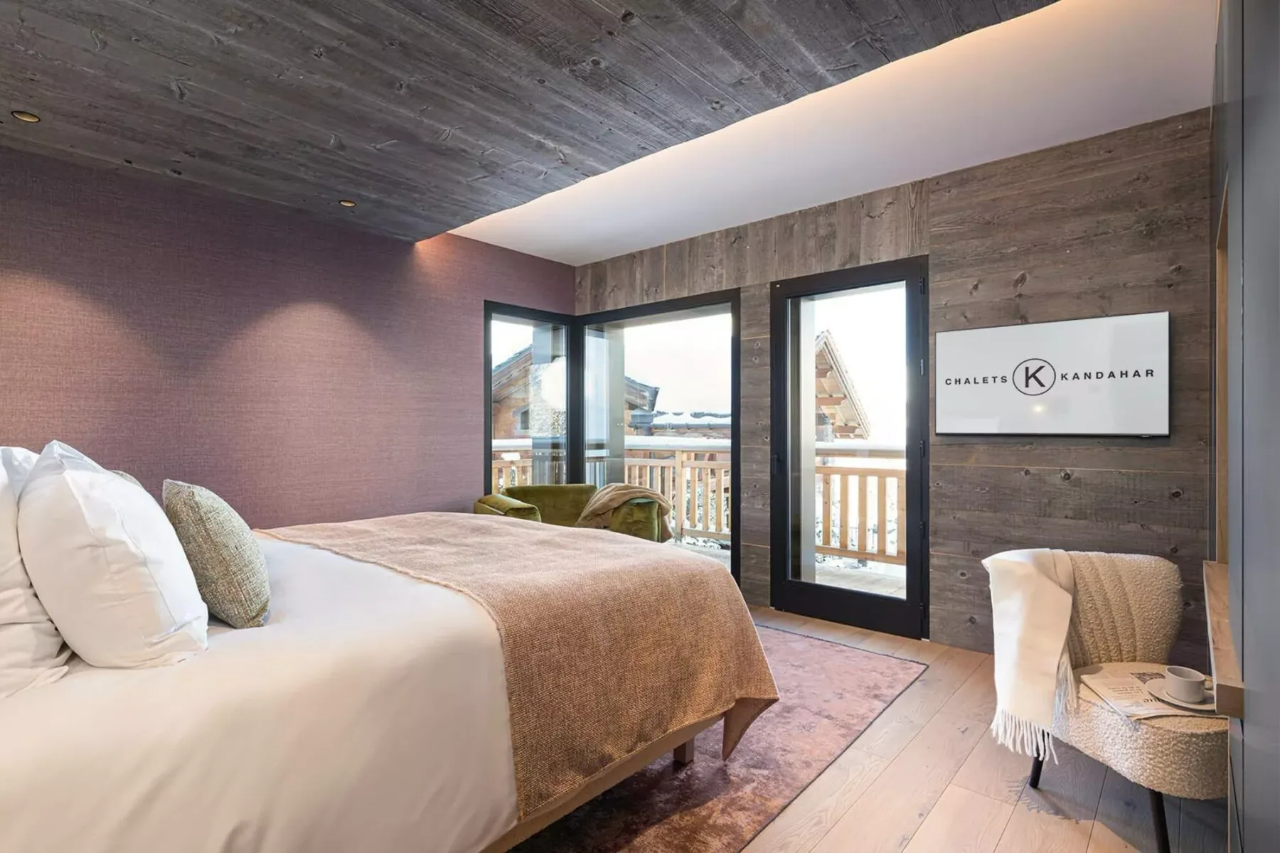 A bedroom with a bed and glass doors opening onto a balcony.