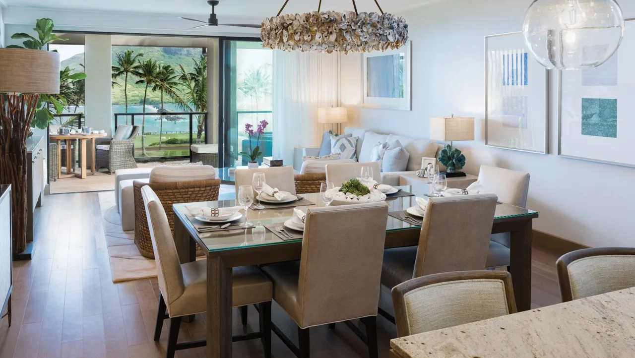 A bright open-plan living and dining area with a set dining table.