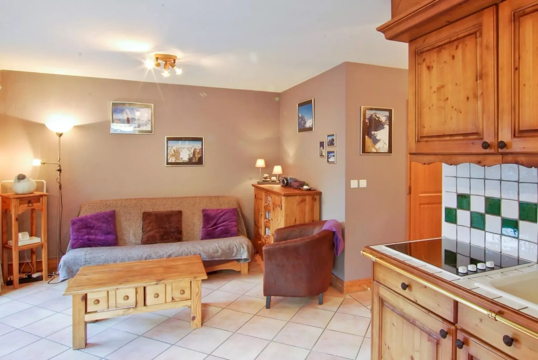 A living area with a sofa, armchair, and wooden coffee table.