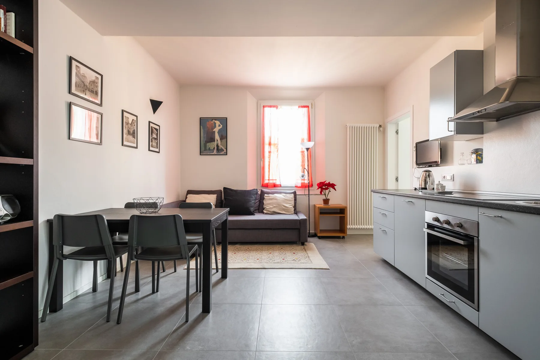 A combined living and kitchen area with a dining table and seating.