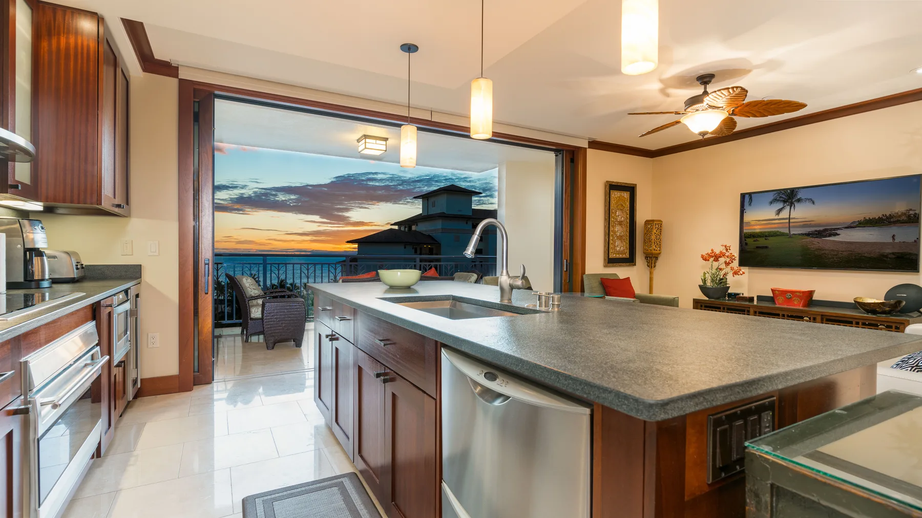 Una cocina con una gran isla se abre a un comedor y un balcón.