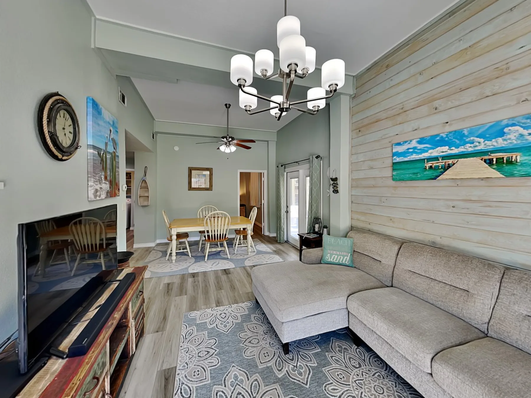 A living room with a sectional seating area and dining table.