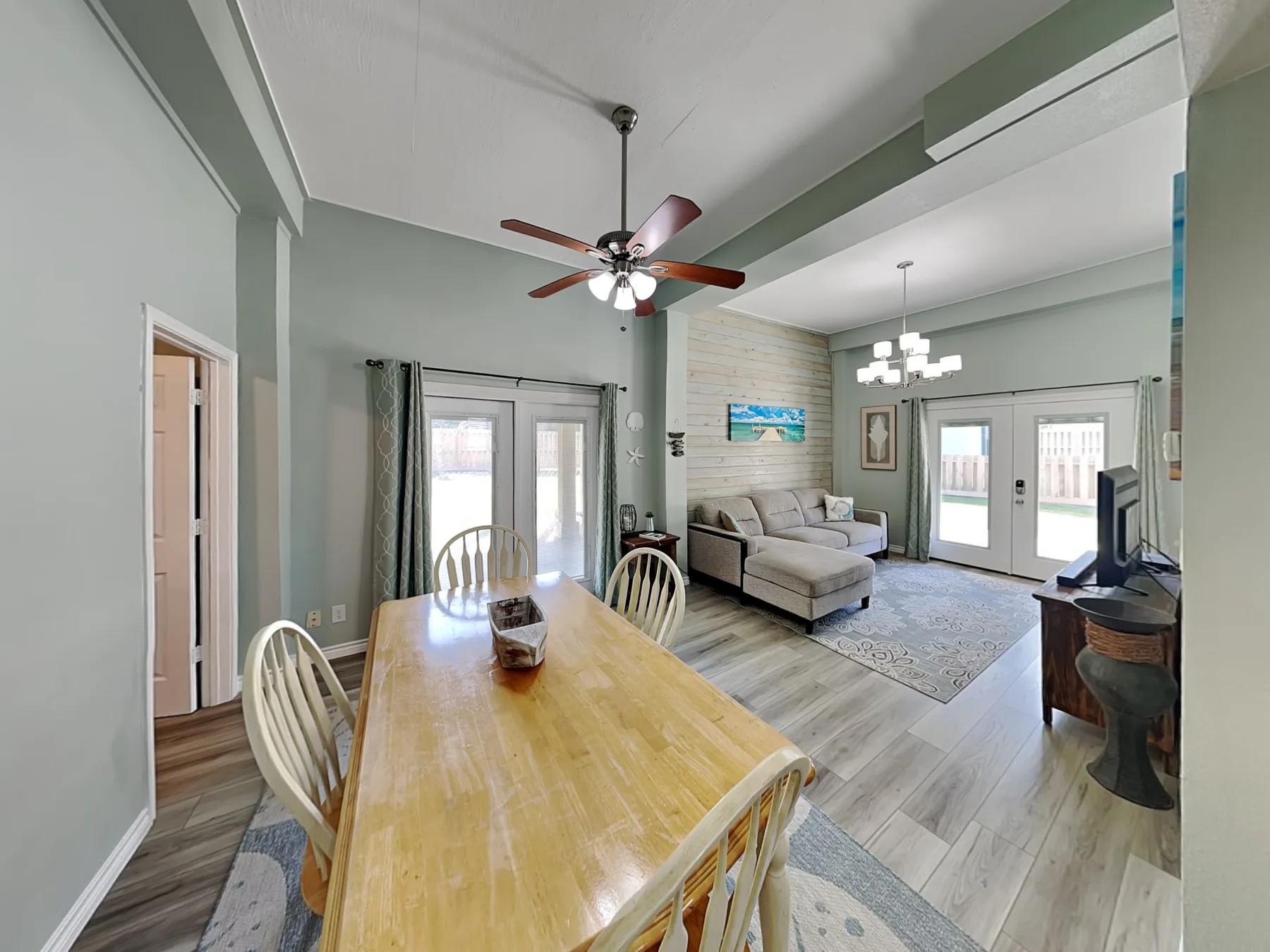 An open dining and living area with a wooden table and seating.