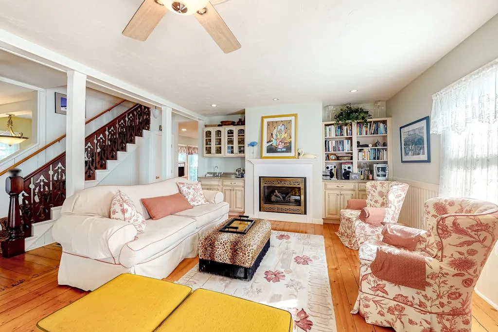 Living room with seating arranged around a fireplace and coffee table.