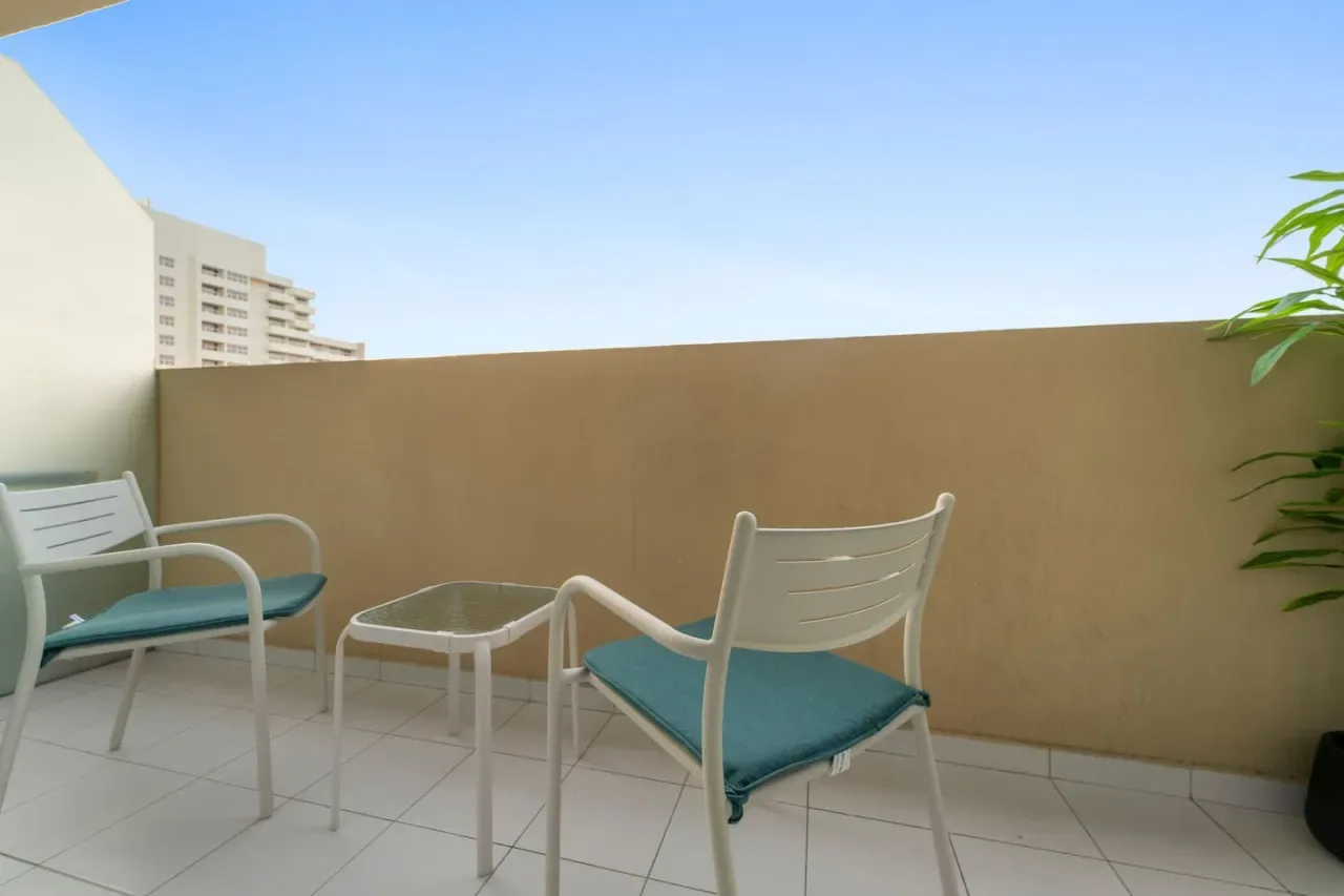 A small outdoor seating area with two chairs and a low table.