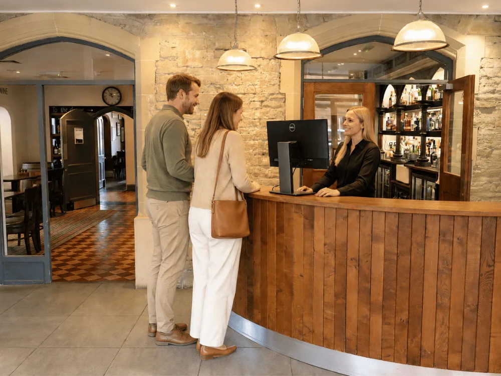 Guests checking in at hotel reception