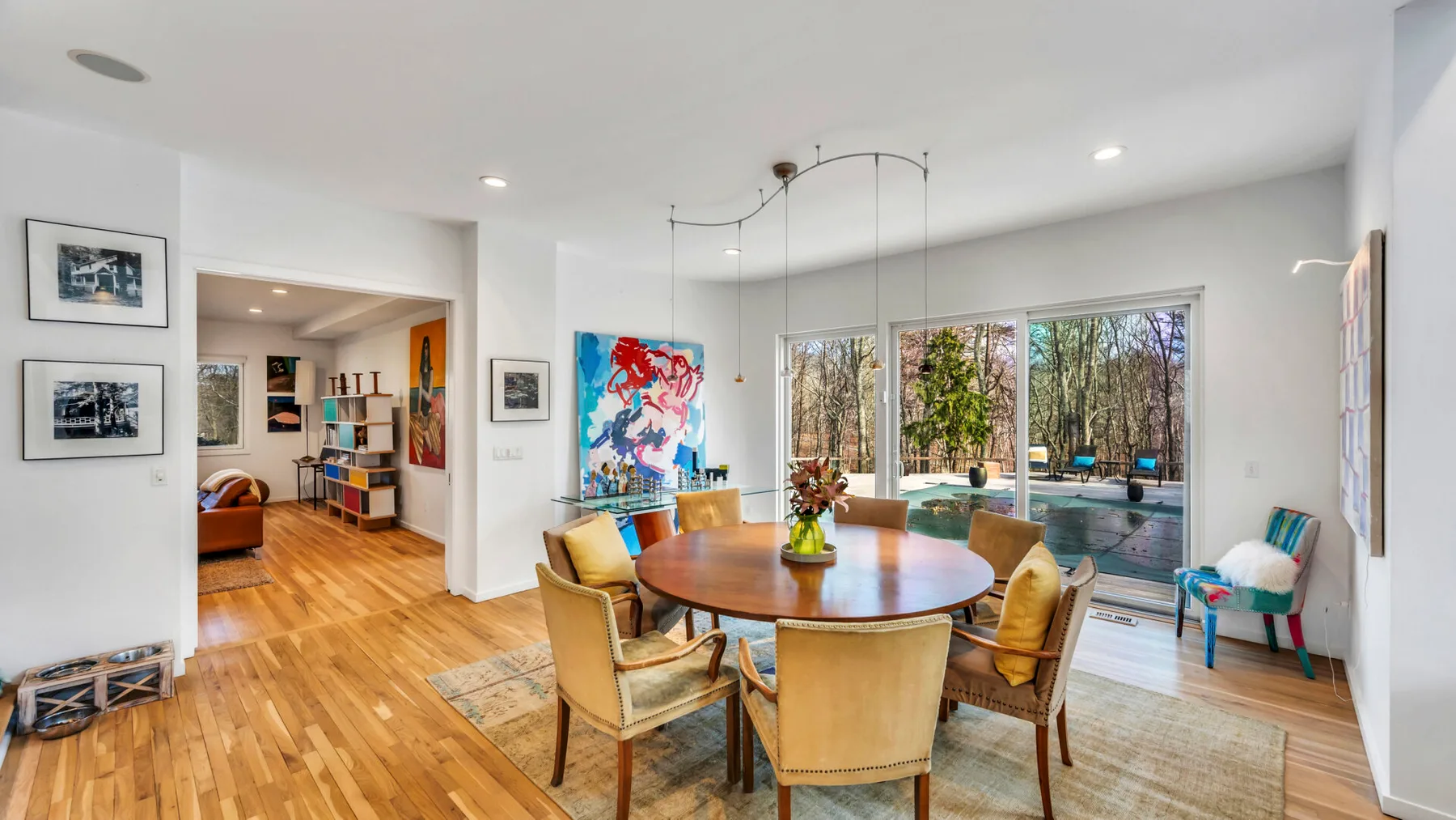 A bright dining area opens onto a patio through large windows.