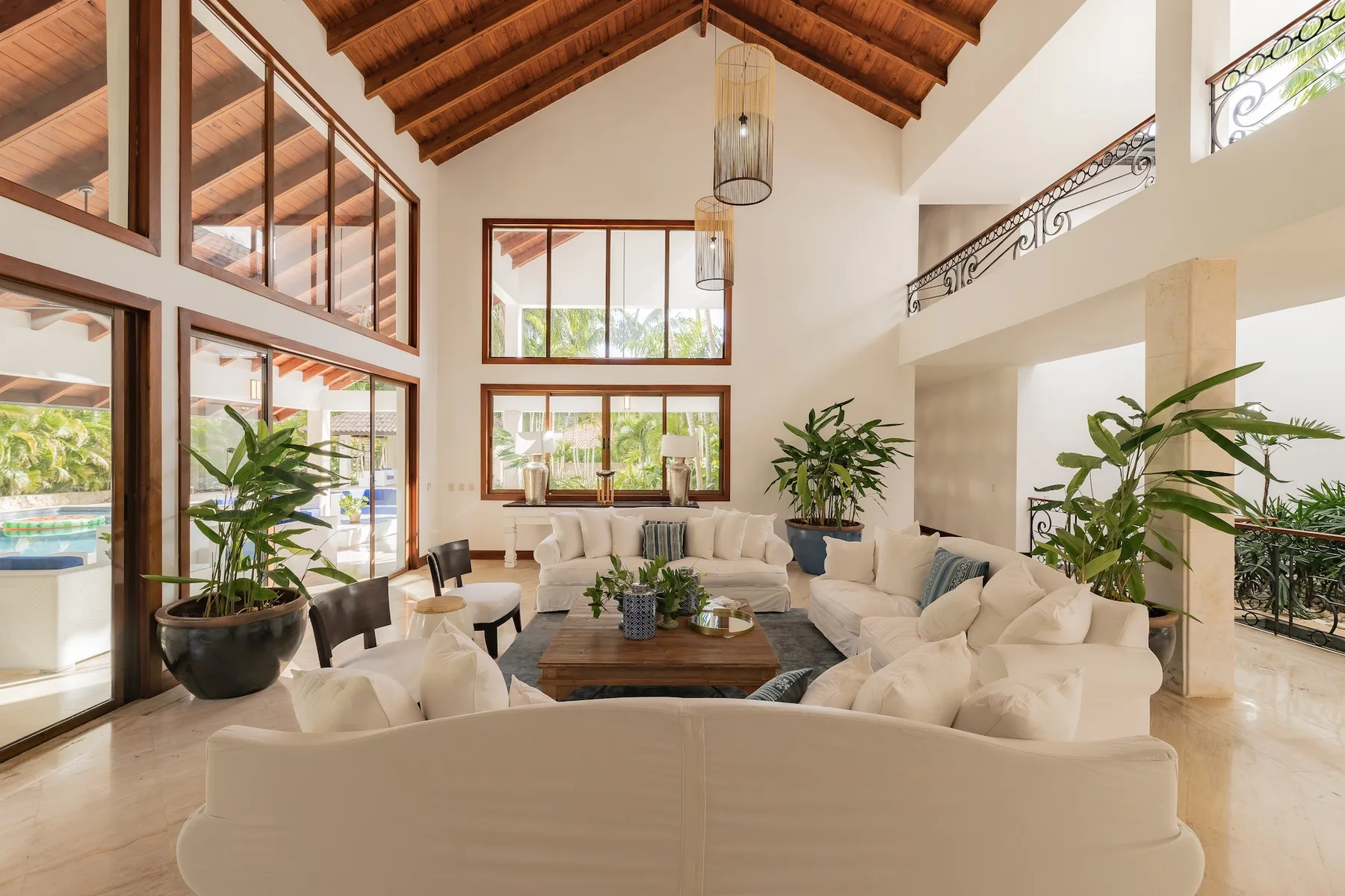 A bright living room with seating arranged around a low coffee table.