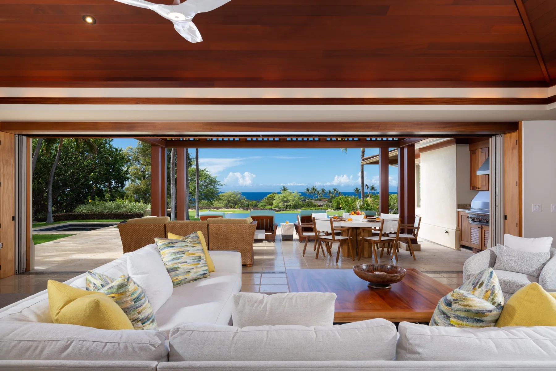 An open-plan living and dining area opens onto a terrace overlooking the ocean.
