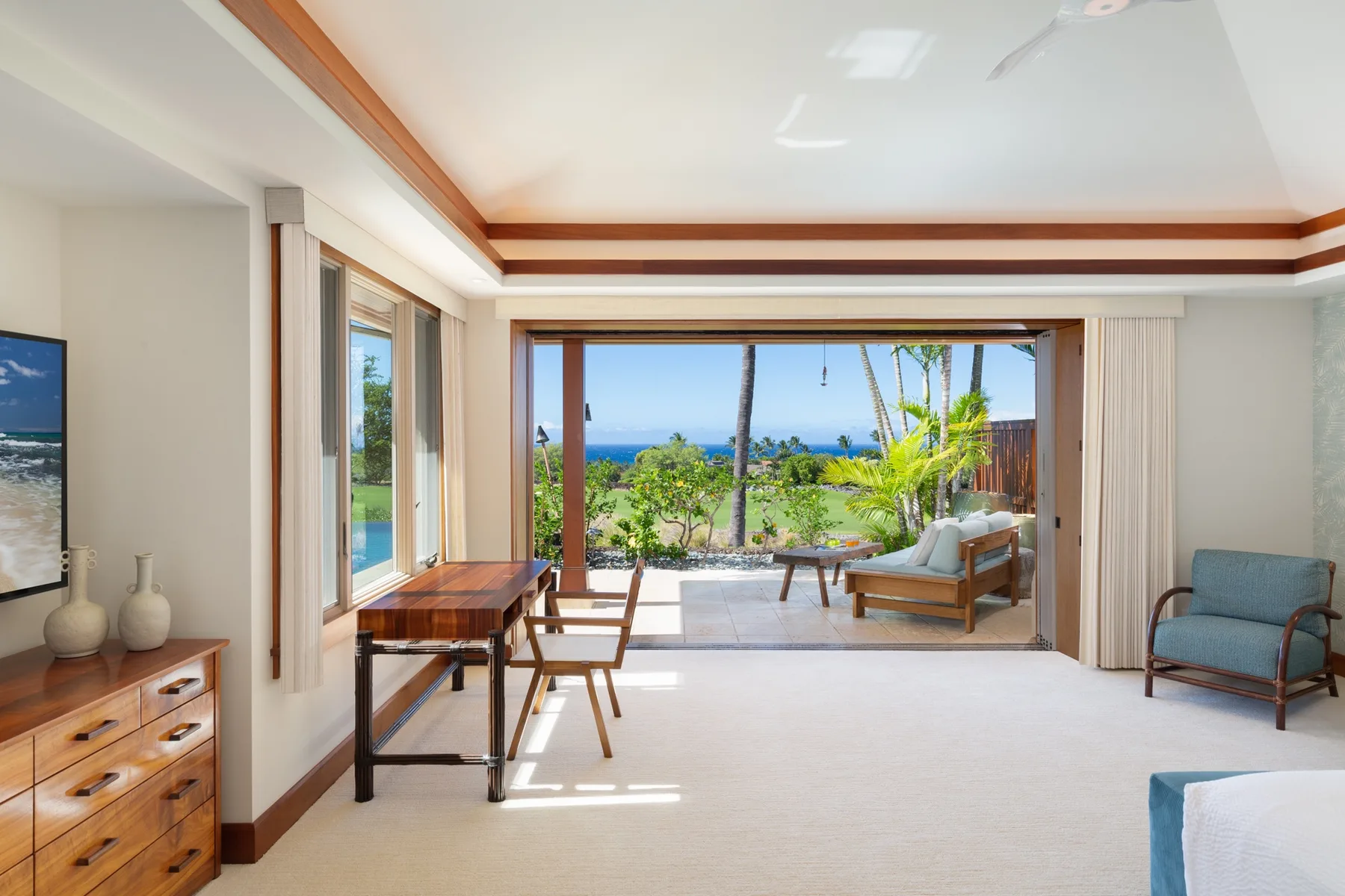 A bright bedroom opens onto a terrace with a view of the sea.