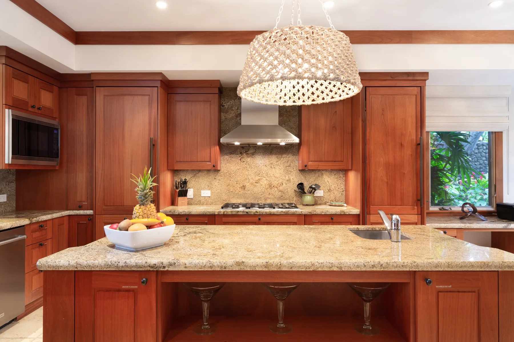 A spacious kitchen with wooden cabinets and a large central island.