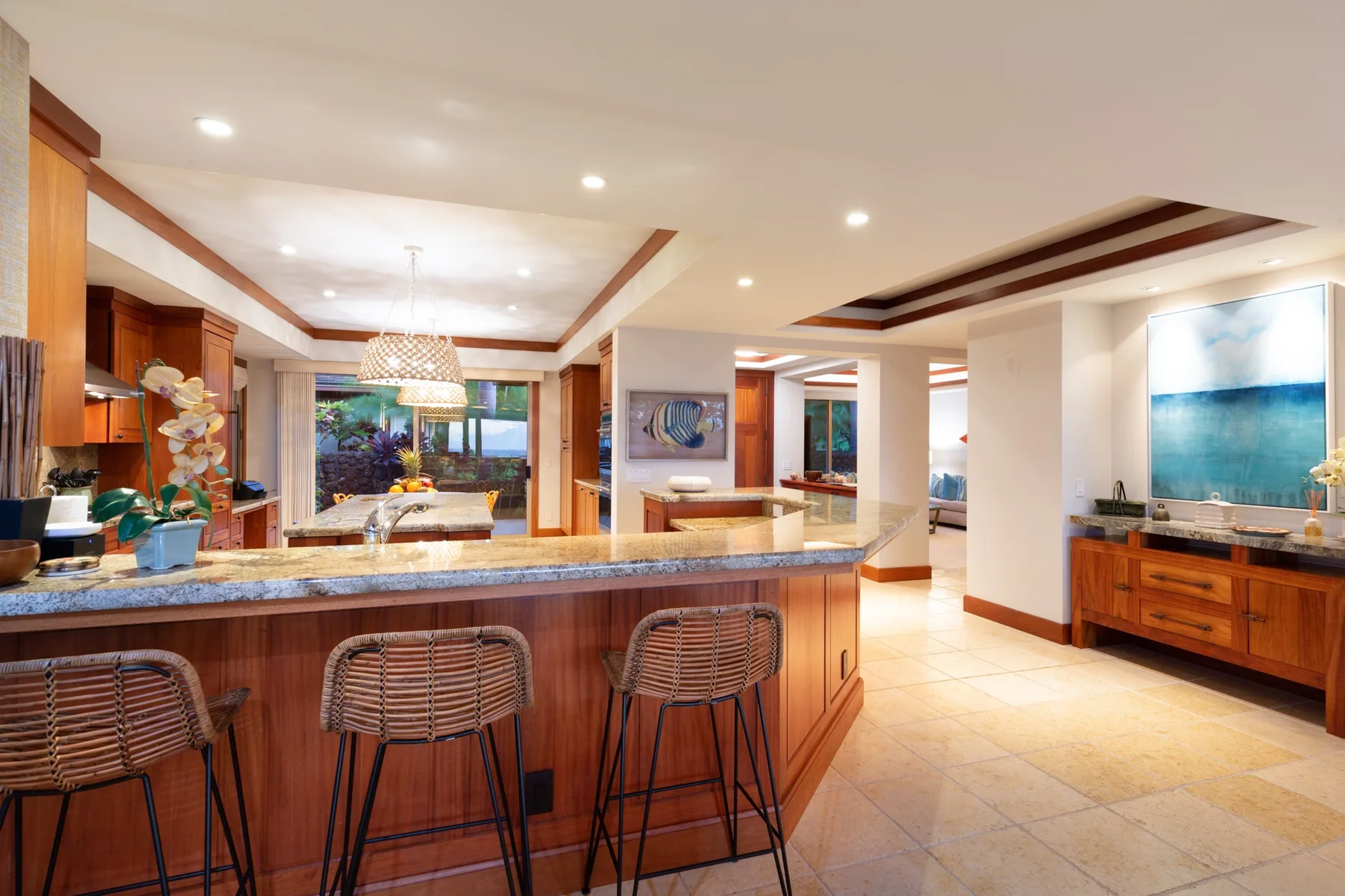 An open kitchen and dining area features a long counter with seating.
