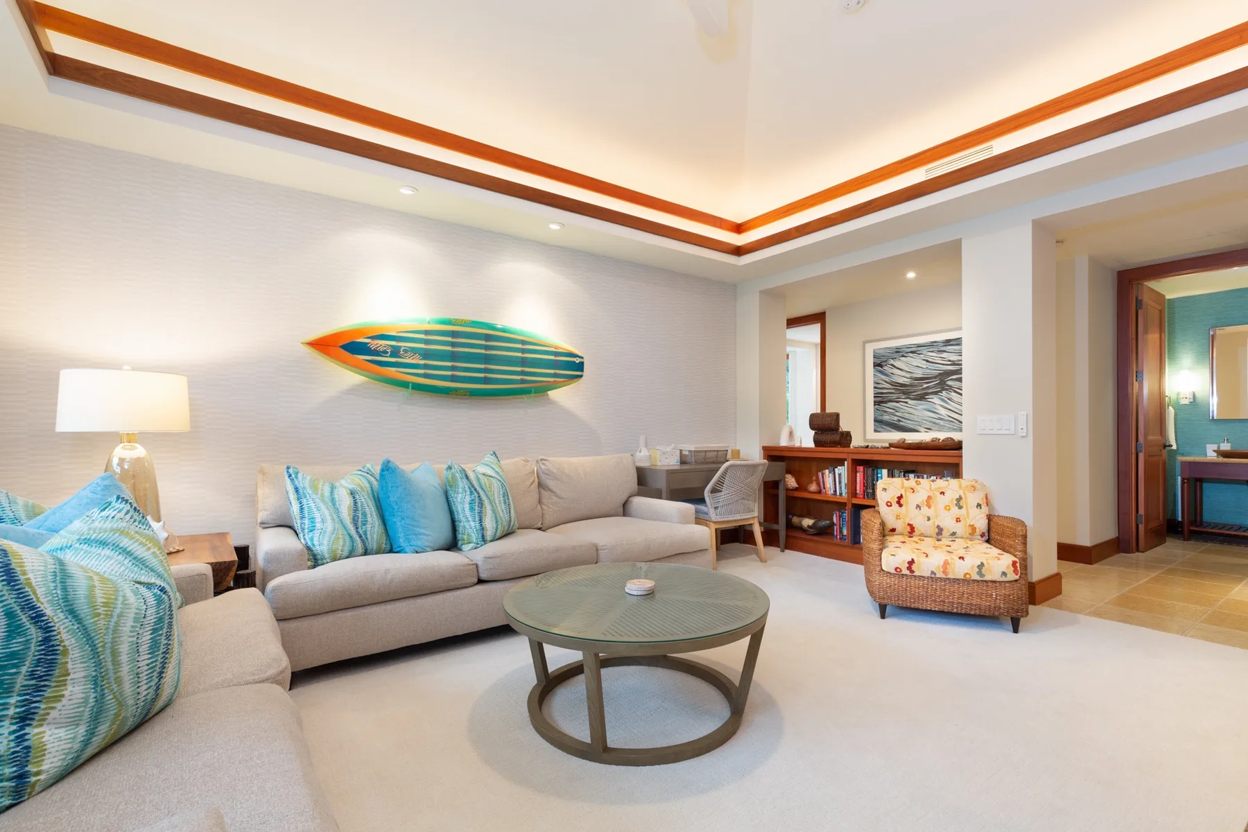 A bright living room with light-colored seating and a round coffee table.