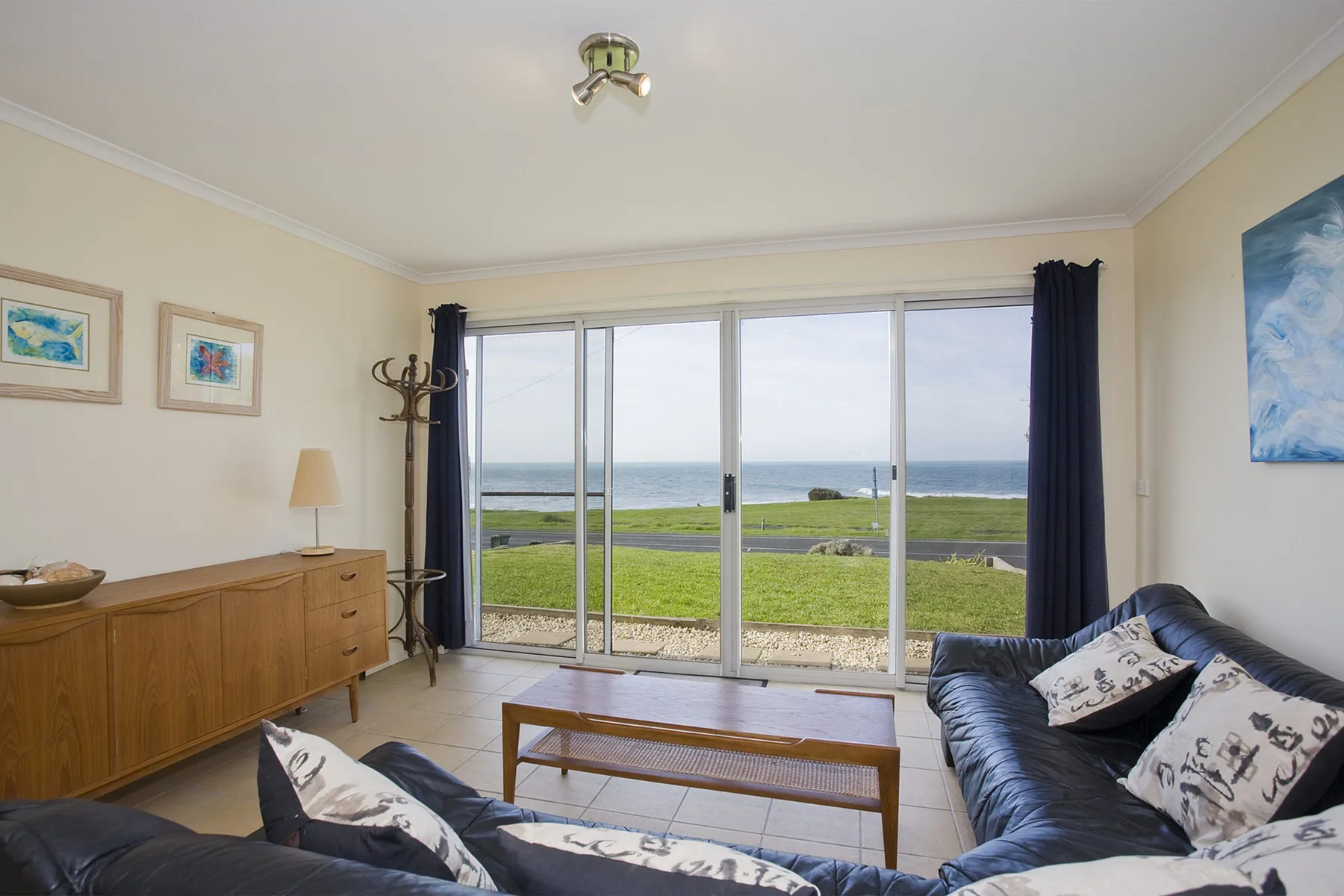 A living room with large windows overlooking the ocean.