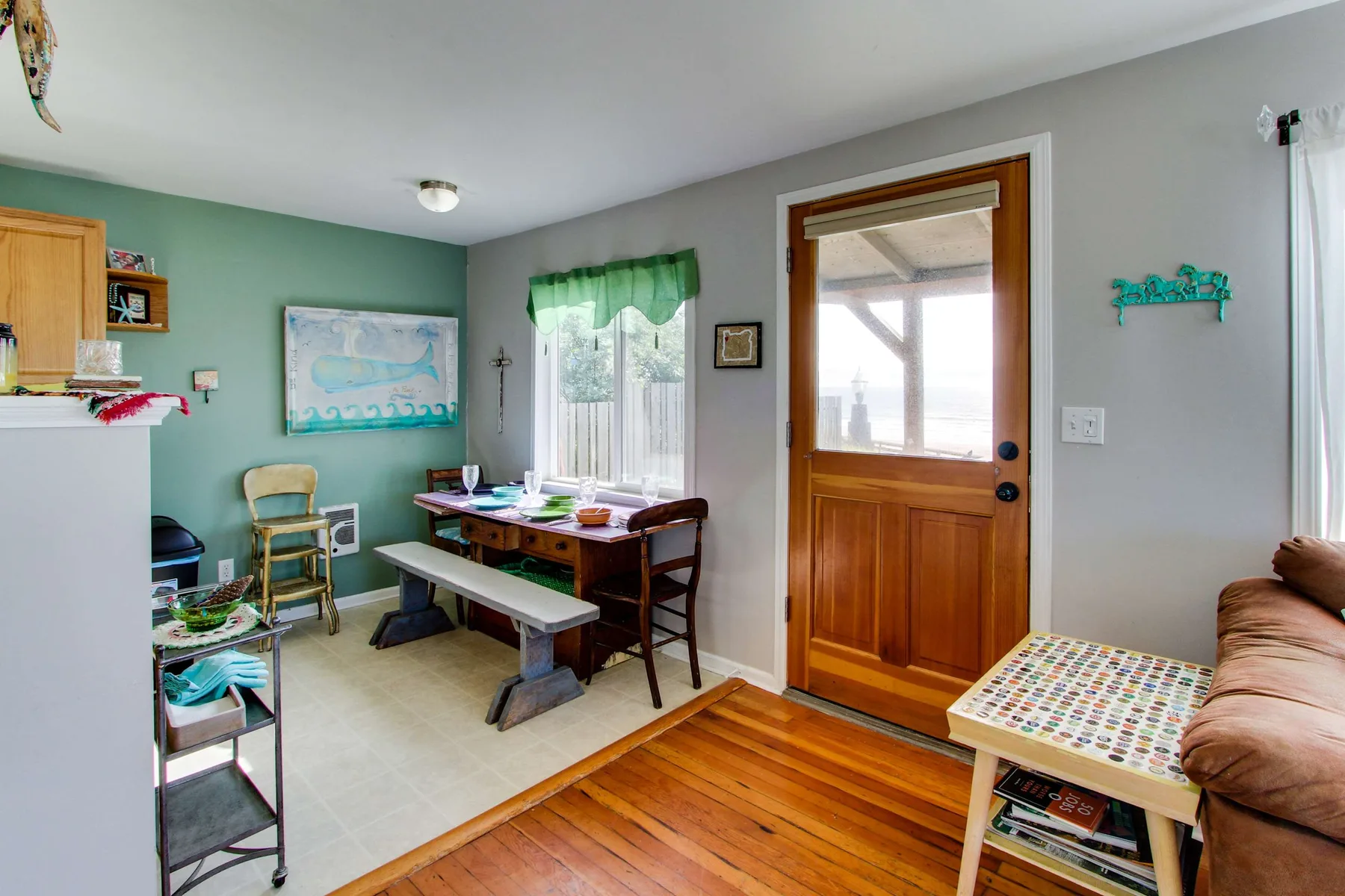 Un comedor con una mesa de madera y asientos junto a una ventana.