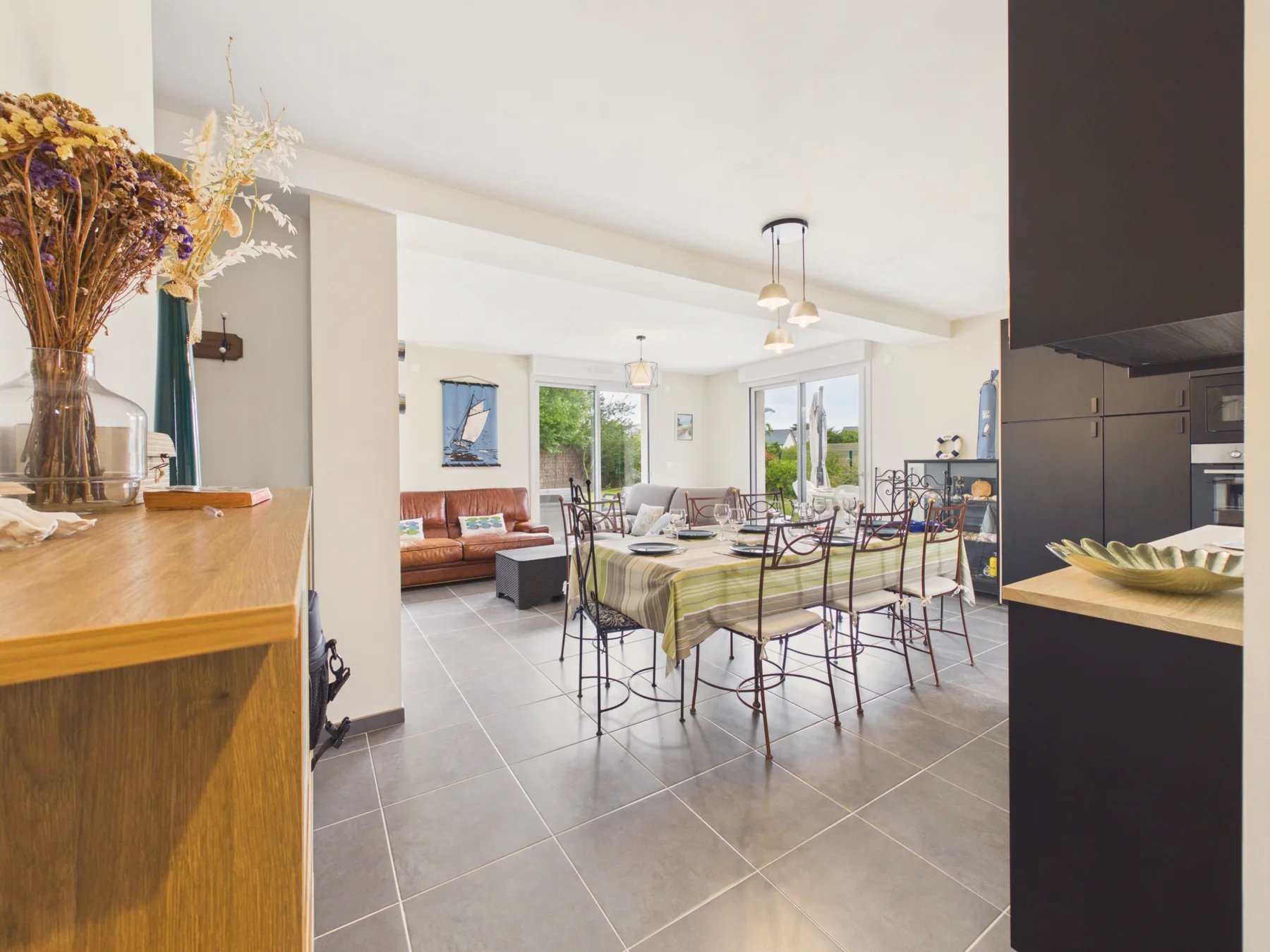 An open-plan living and dining area with a dining table and seating.