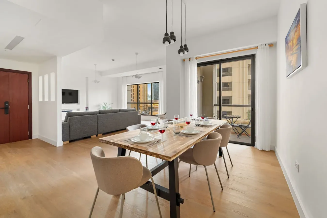 Un comedor y sala de estar de planta abierta, con una mesa puesta y asientos.