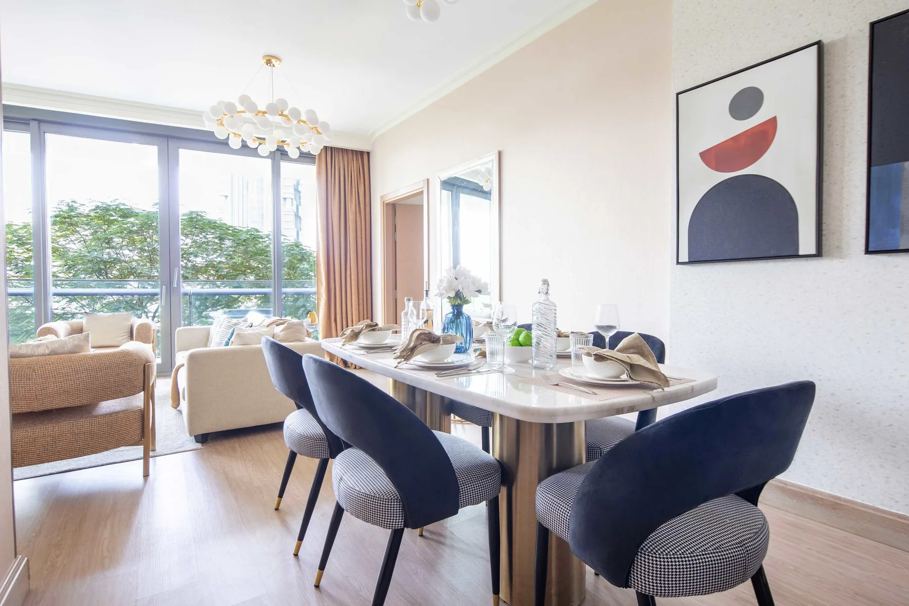 A bright dining area with a set table beside large windows.