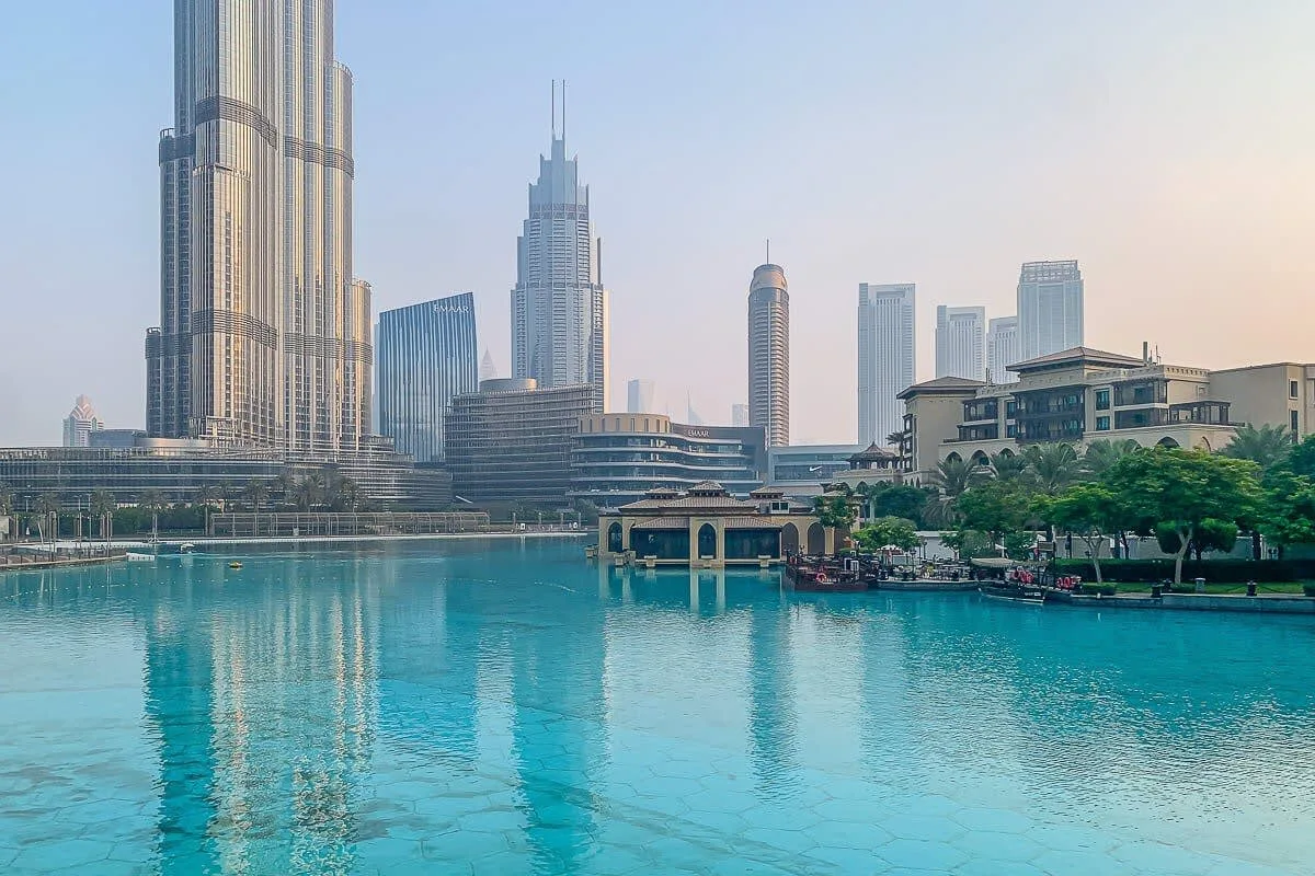 A city skyline rises beside a turquoise waterfront.