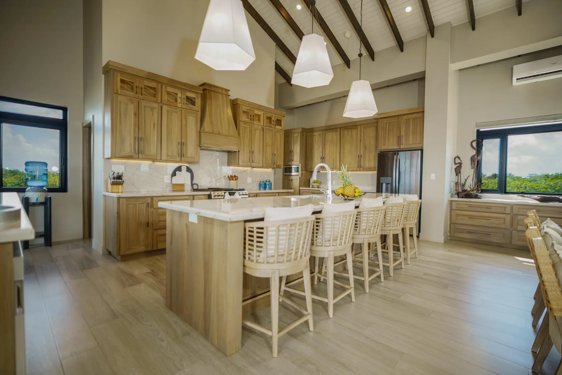 A spacious kitchen with a central island and wooden cabinetry.