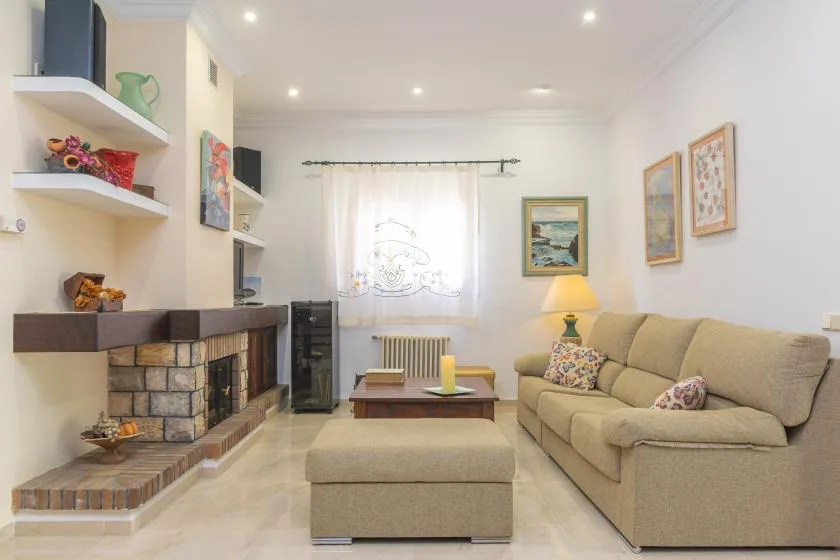 A bright living room with a fireplace, upholstered seating, and a coffee table.
