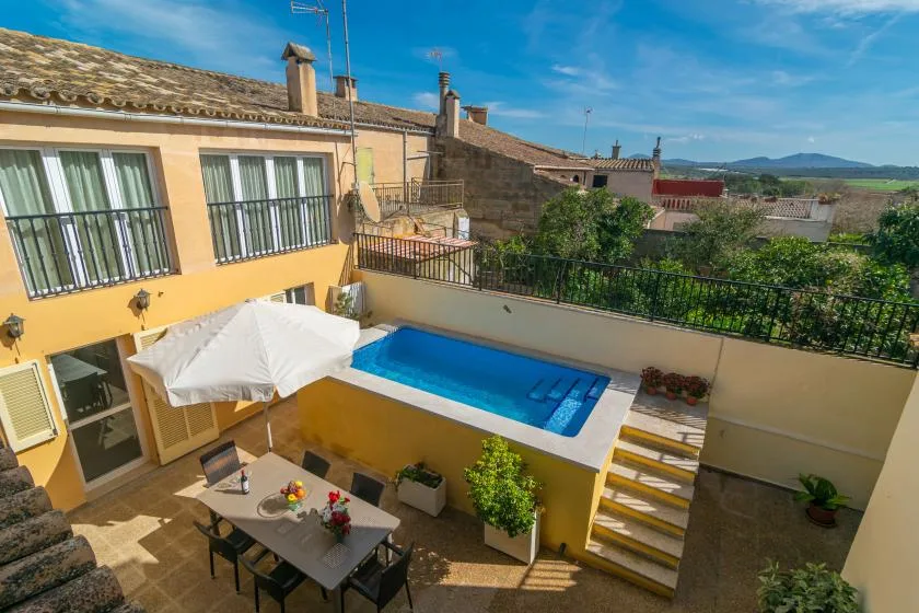 A courtyard patio features a small rectangular pool and outdoor seating.