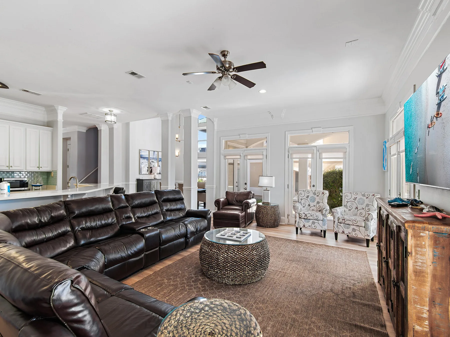 Living room with dark seating, a round coffee table, and large windows.
