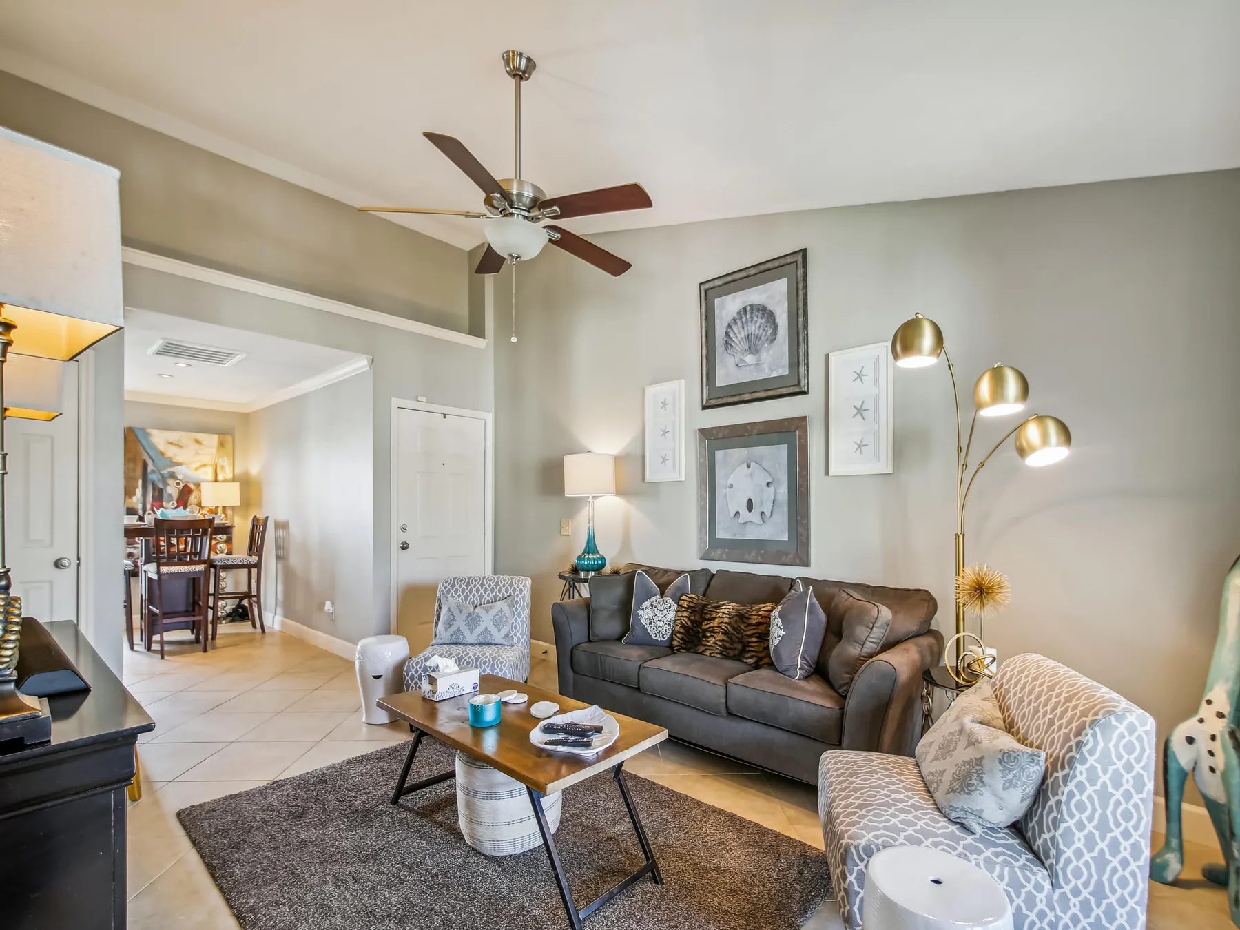 A living room with a sofa, armchairs, and a coffee table.