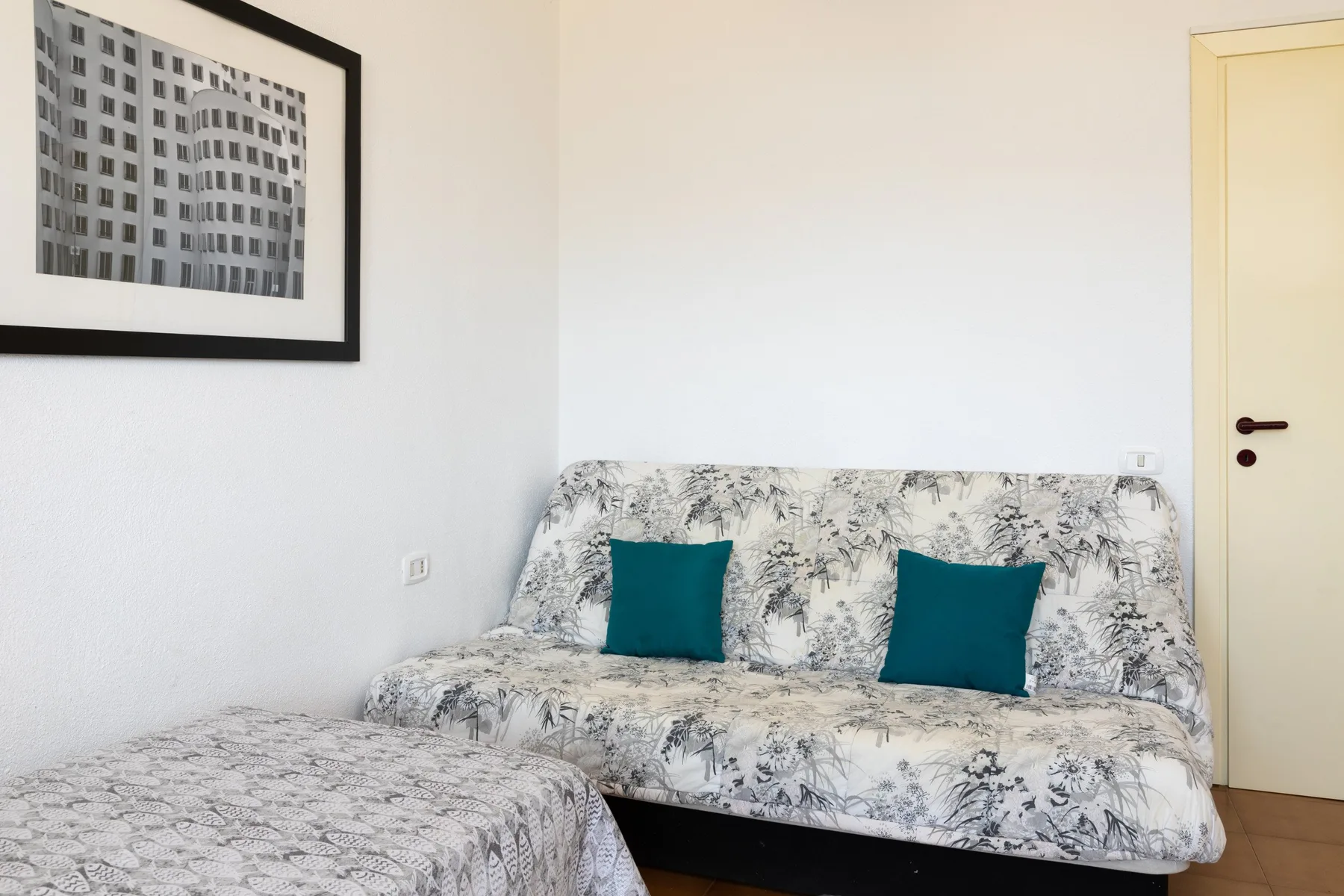 Una zona de estar con un sofá estampado y muebles tapizados a juego.