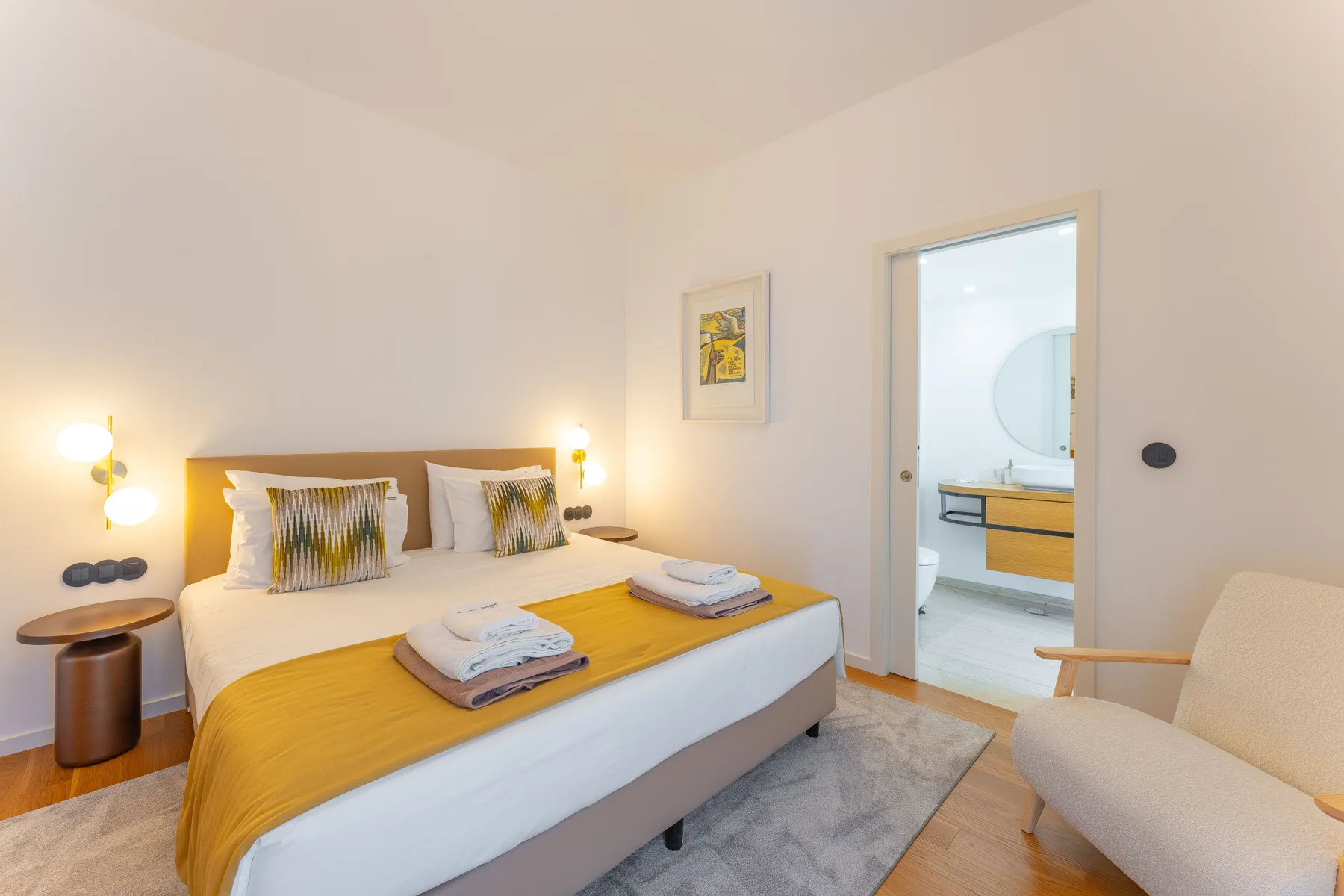 A bedroom with a double bed and a doorway opening onto a bathroom.