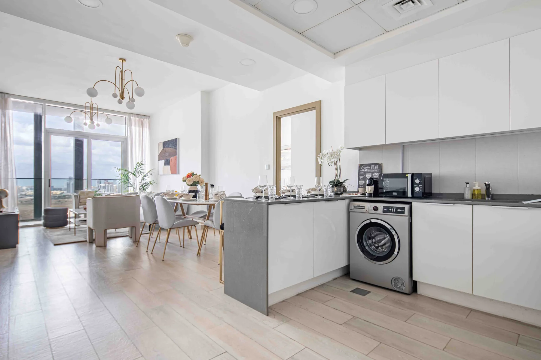 A bright open-plan kitchen and dining area with large windows.