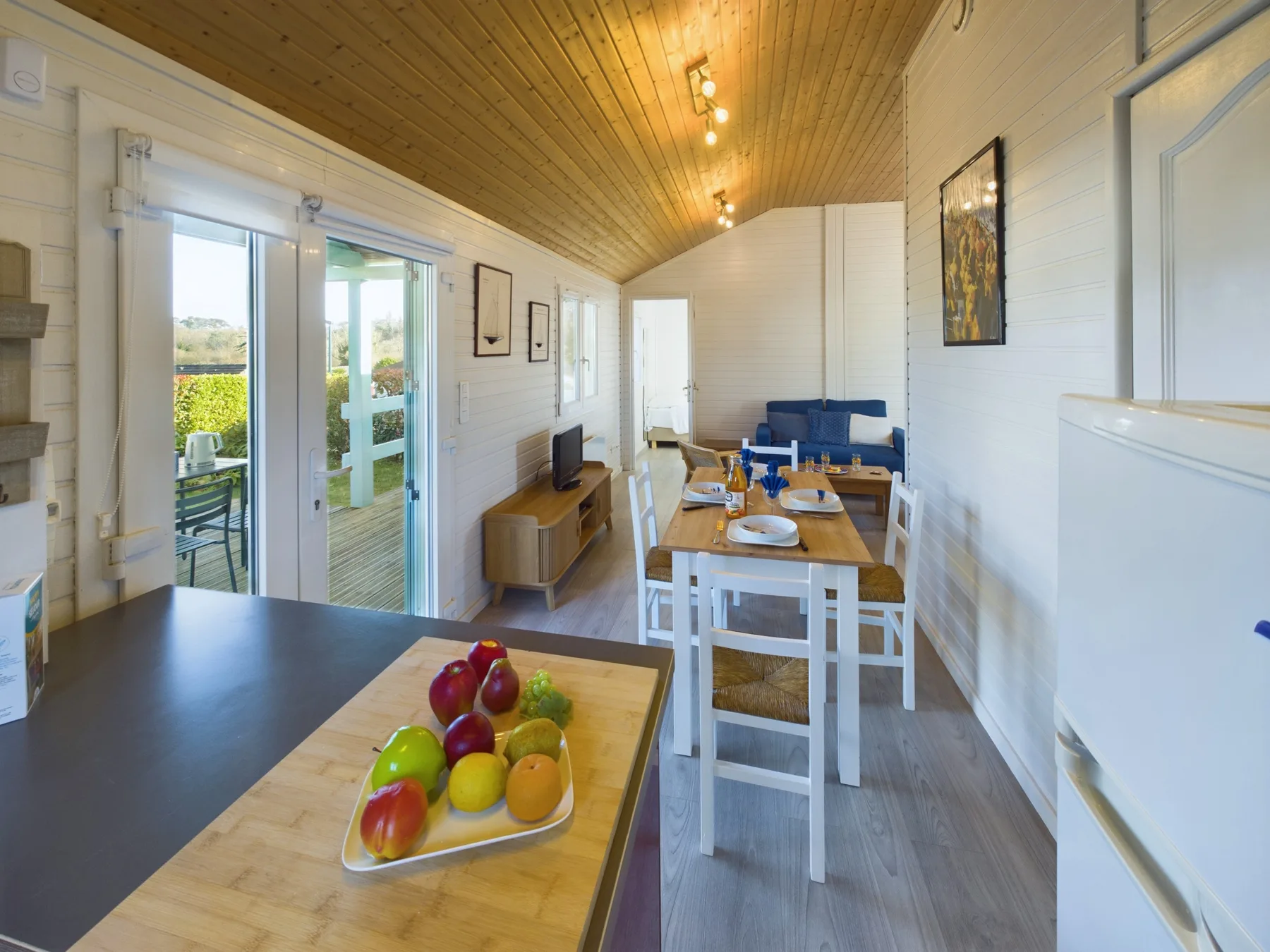 A bright dining and living area opens onto a small patio.
