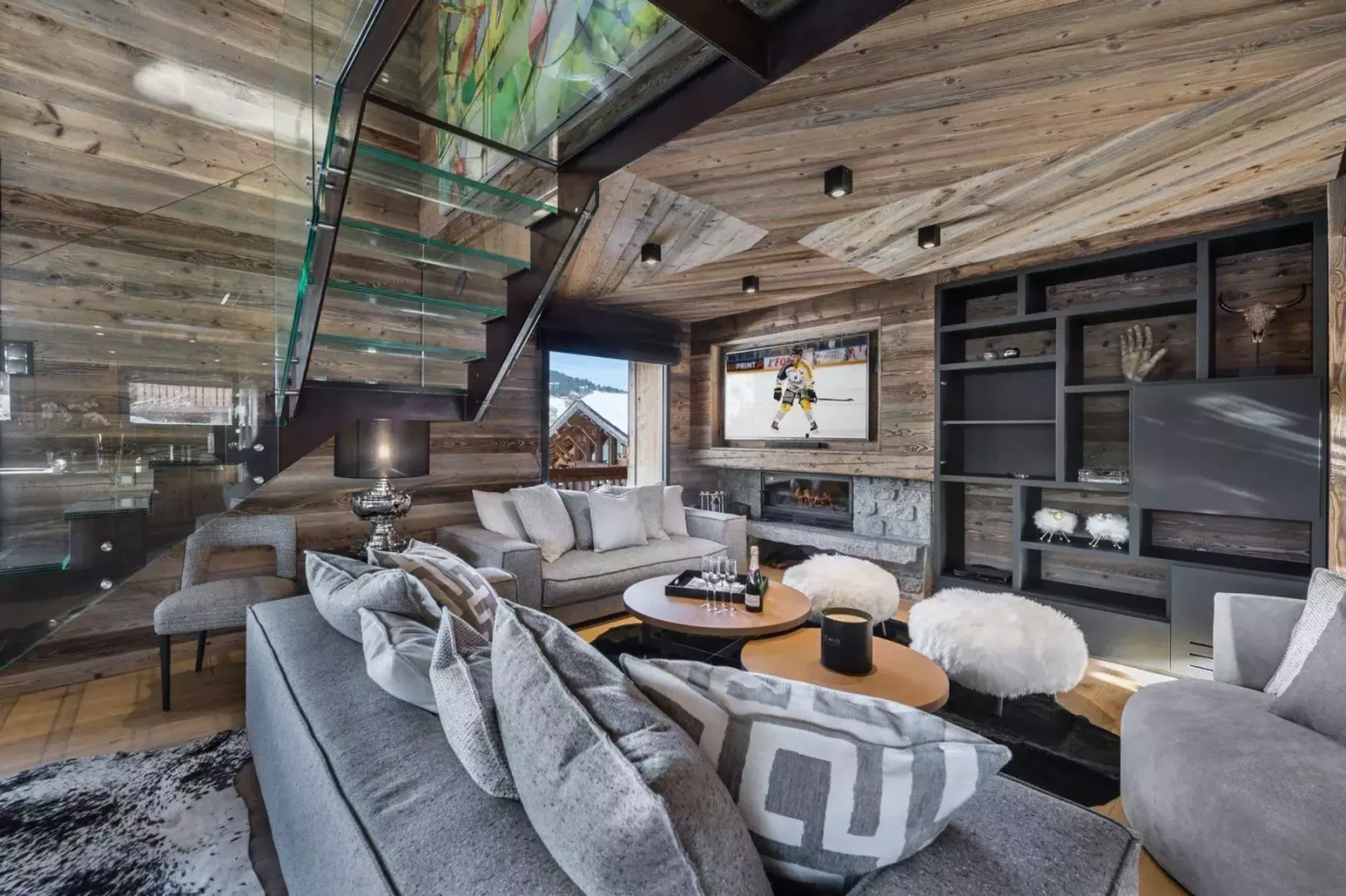 A living room with seating arranged around a coffee table and fireplace.