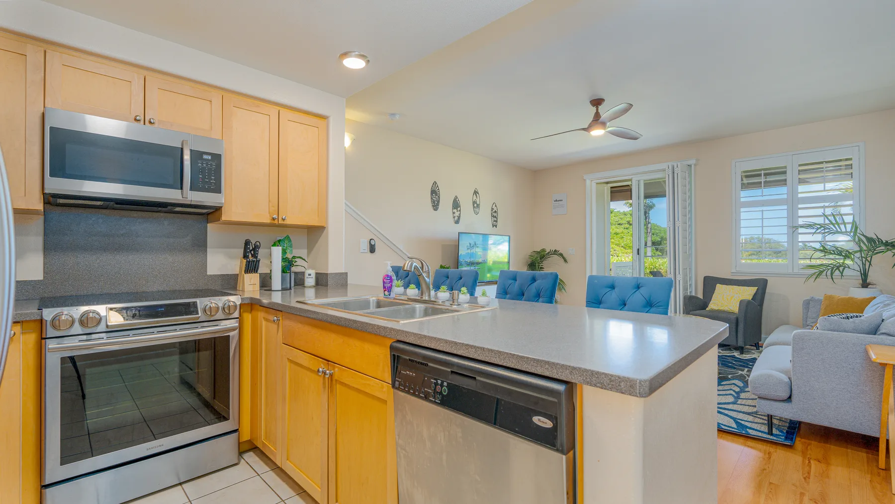An open-plan kitchen and living area with a central island and seating.