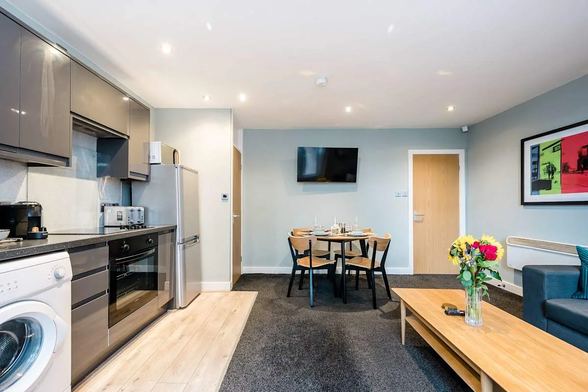 A modern open-plan kitchen and dining area with a seating area.