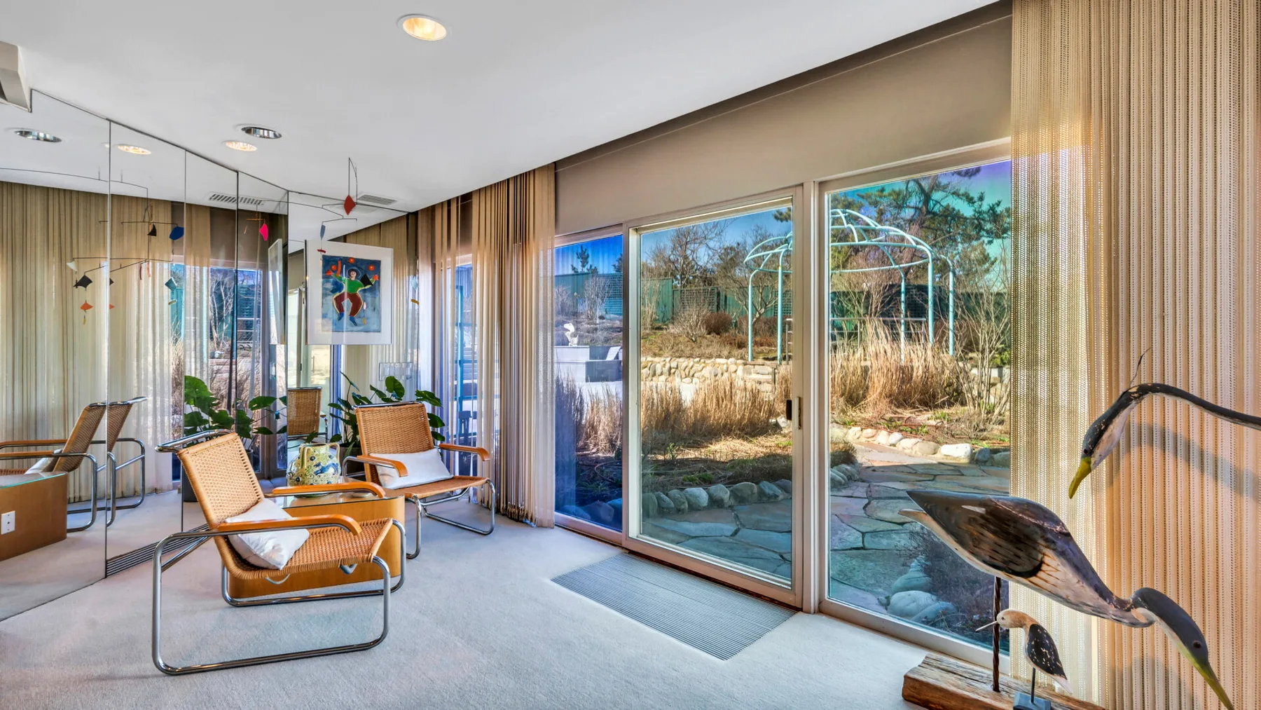 A bright sitting area with glass doors opening onto a garden patio.